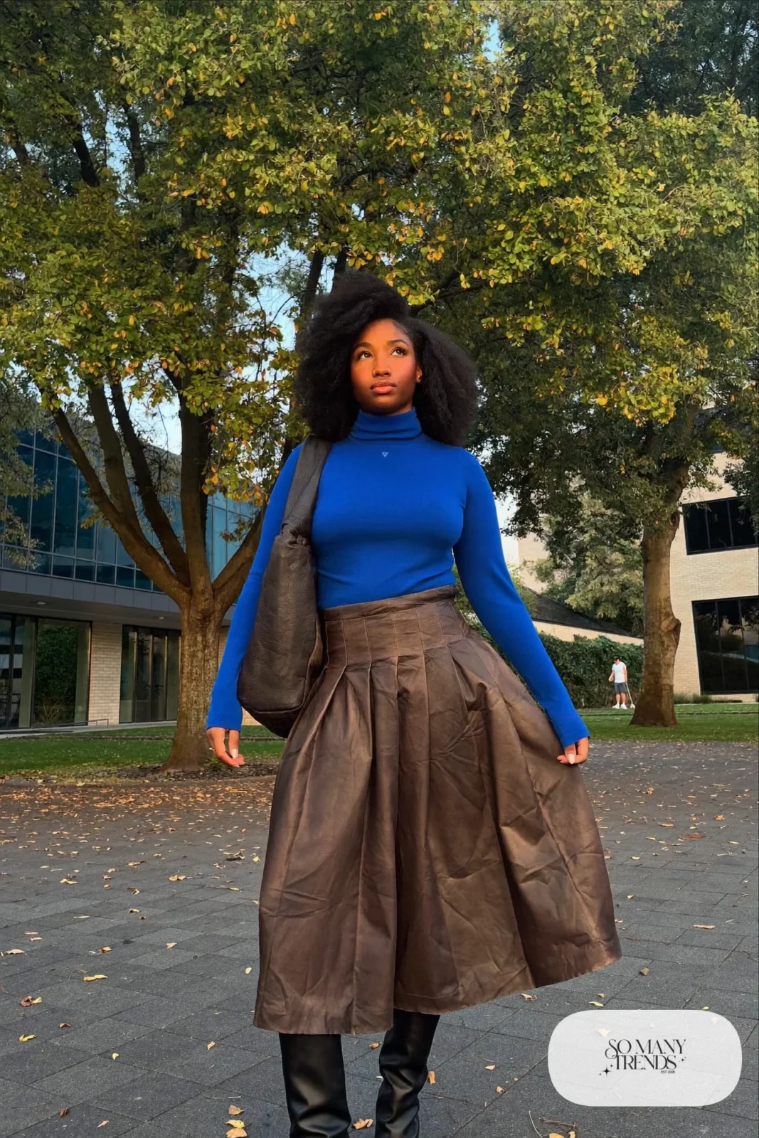 Woman with pear-shaped figure in a cobalt turtleneck, espresso pleated midi skirt and black knee boots, outfit 13