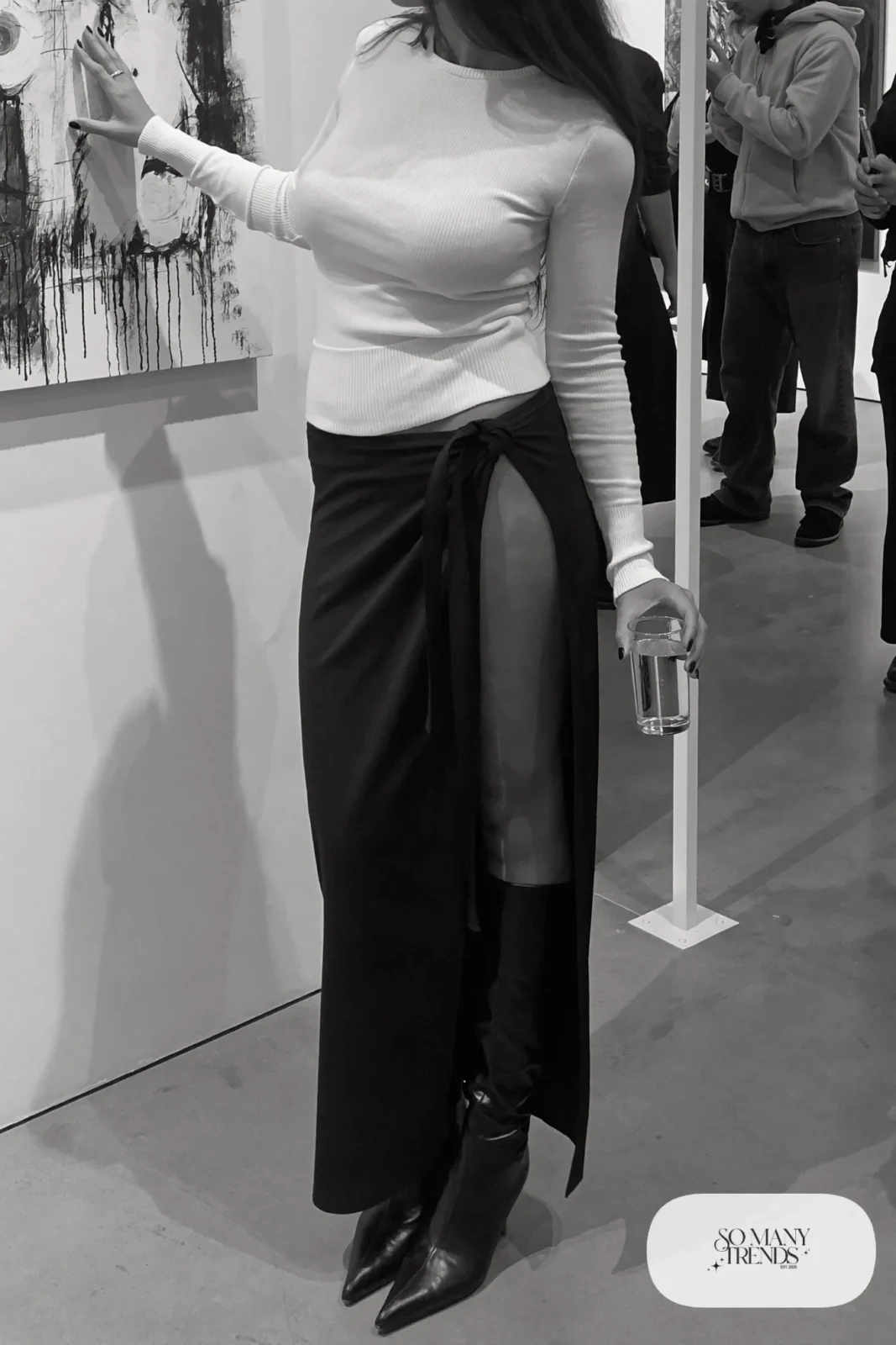 Woman with pear-shaped figure in a fitted white knit, black wrap midi skirt and black pointed knee boots, outfit 17