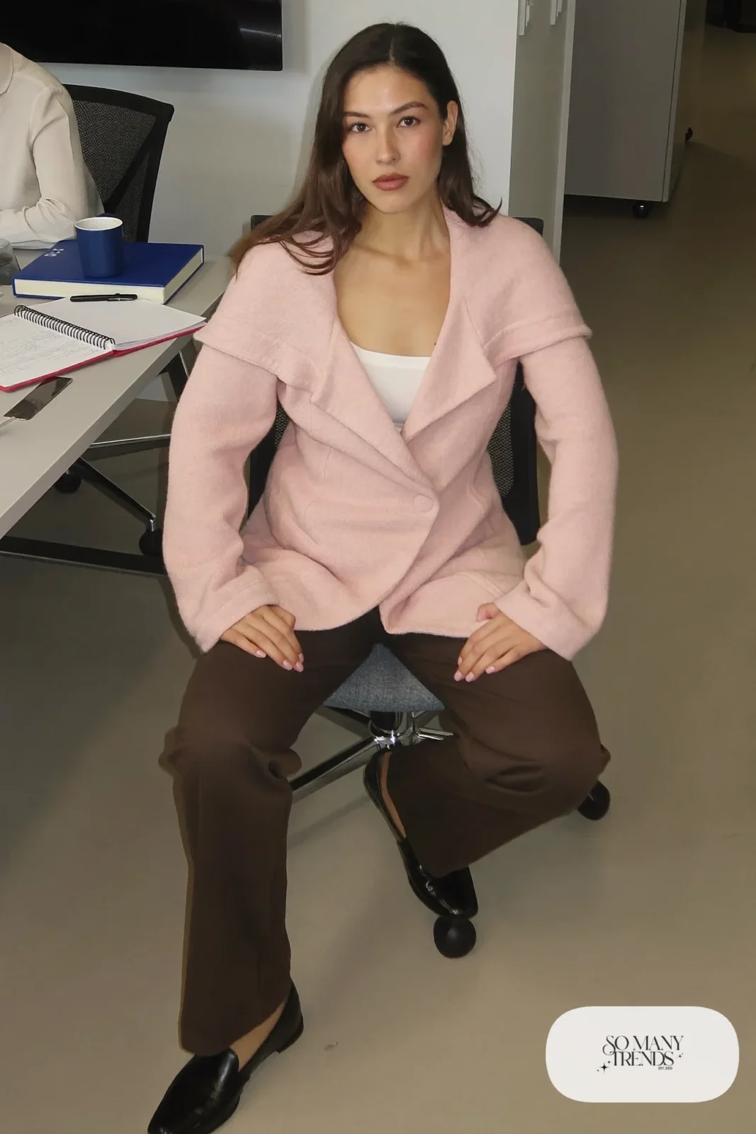 Woman with pear-shaped figure in a pale pink shawl-collar cardigan, white tank, espresso pants and loafers, outfit 18