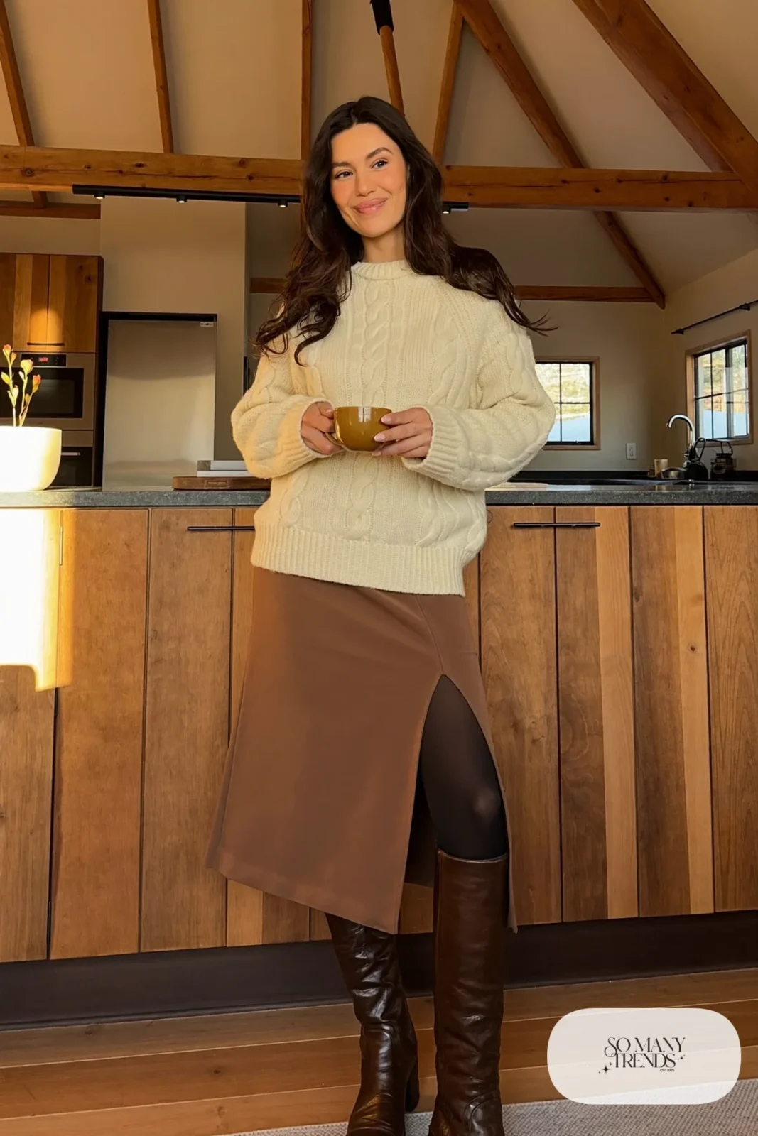 Woman with pear-shaped figure in a cream cable knit sweater, brown midi pencil skirt and tall brown boots, outfit 24