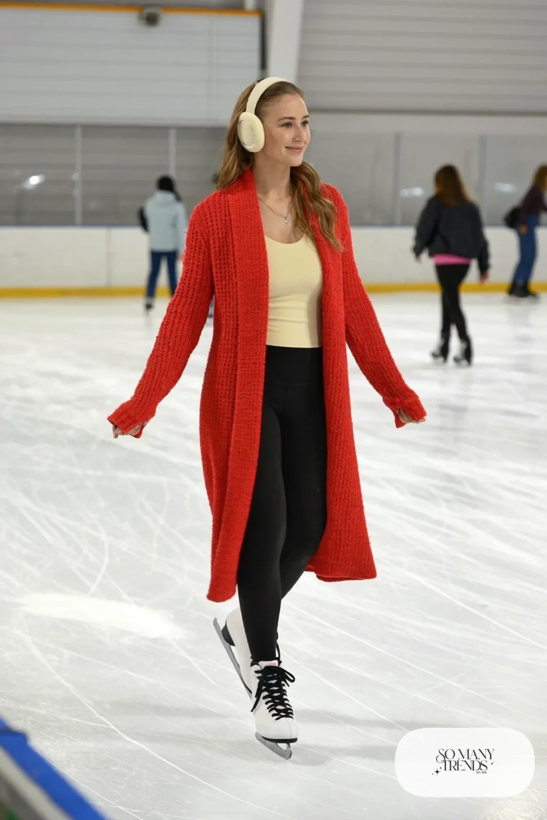 Long cranberry cardigan coat over cream thermal top, black leggings, knit ear warmers and ice skates - outfit 3
