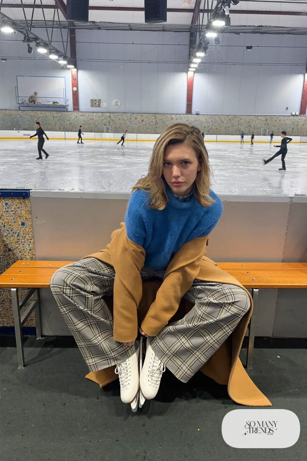 Sky blue cropped knit sweater with high-waist gray-and-cream plaid wide pants, camel coat and ice skates - outfit 11