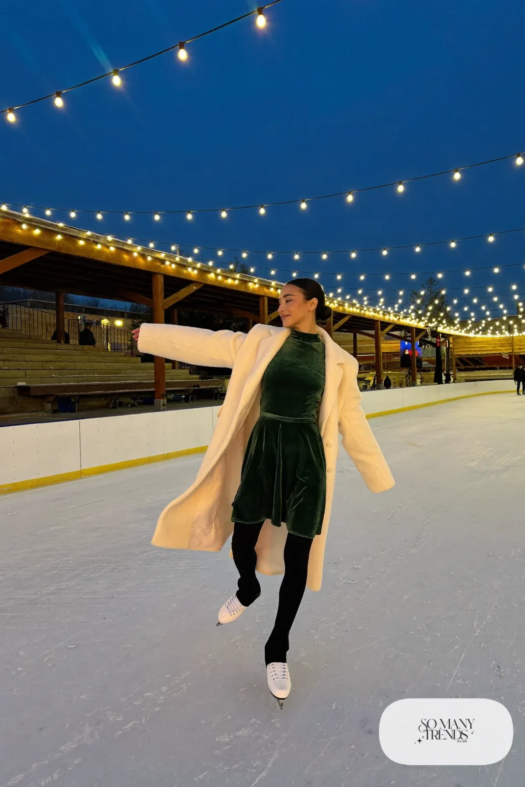 Forest green velvet long-sleeve skater dress, black fleece tights, cream wool coat and ice skates - outfit 12