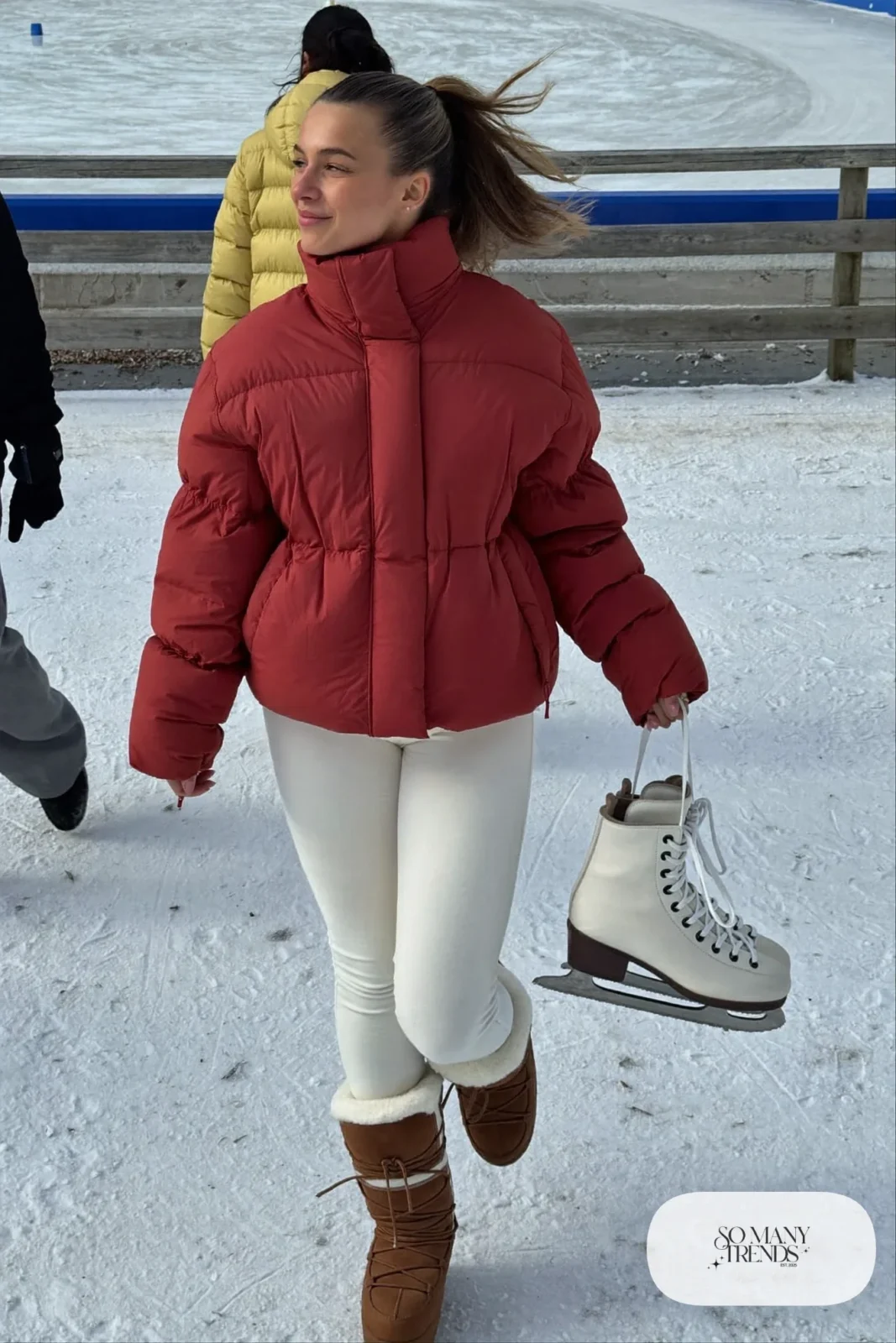 Cranberry hip-length puffer jacket, cream fleece leggings and mocha snow boots, carrying ice skates - outfit 25