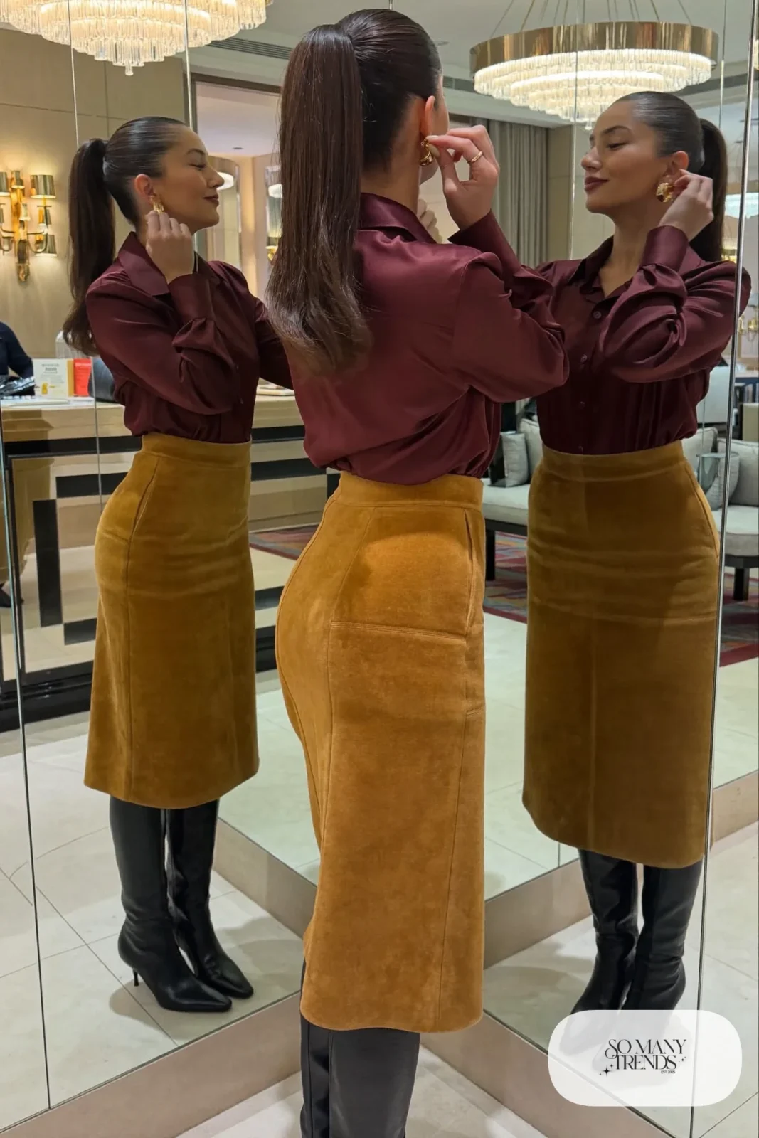 Woman in burgundy satin shirt, camel midi skirt and tall boots, NFR outfit 17