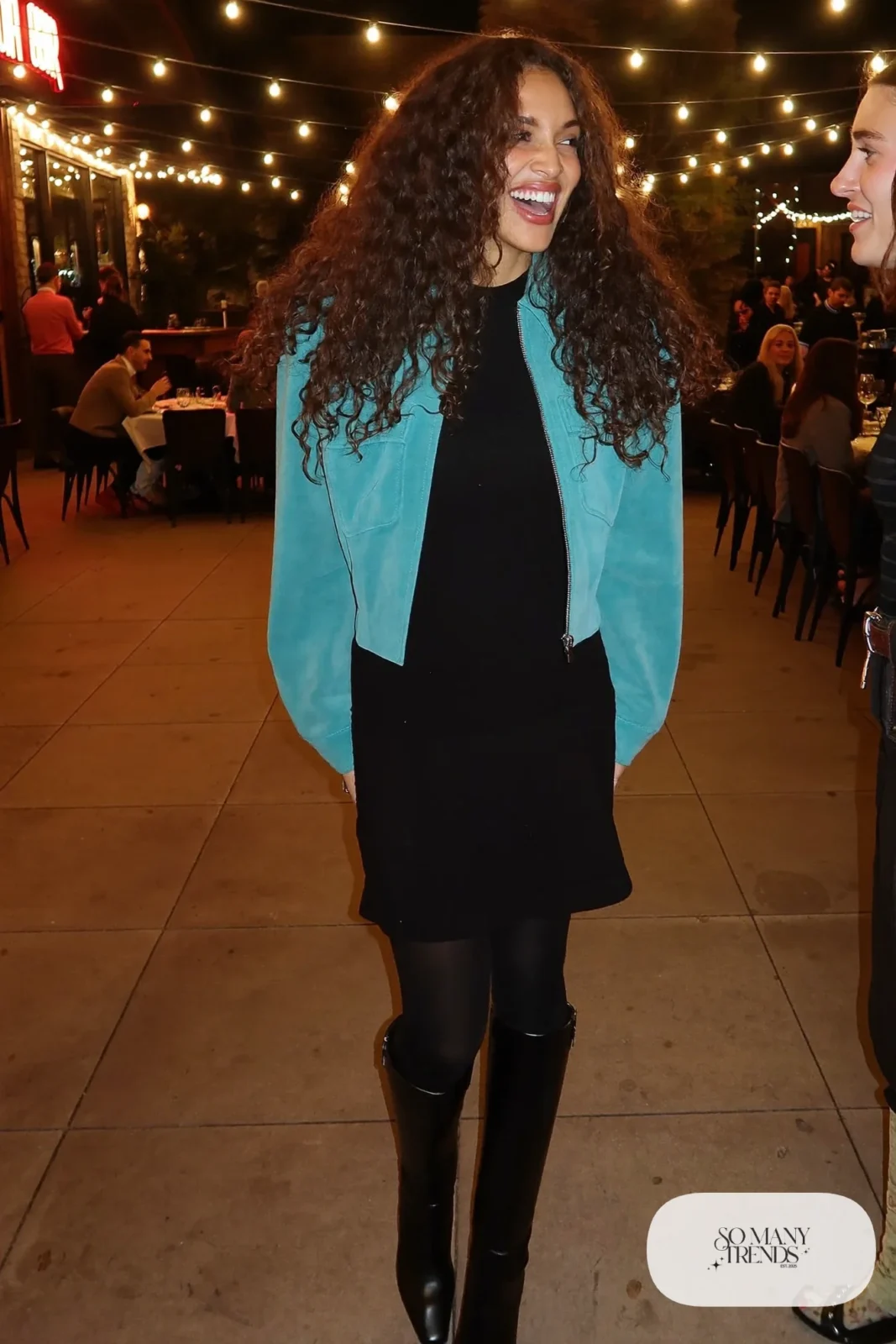 Woman in turquoise suede jacket, black knit midi dress and tall black boots, NFR outfit 21