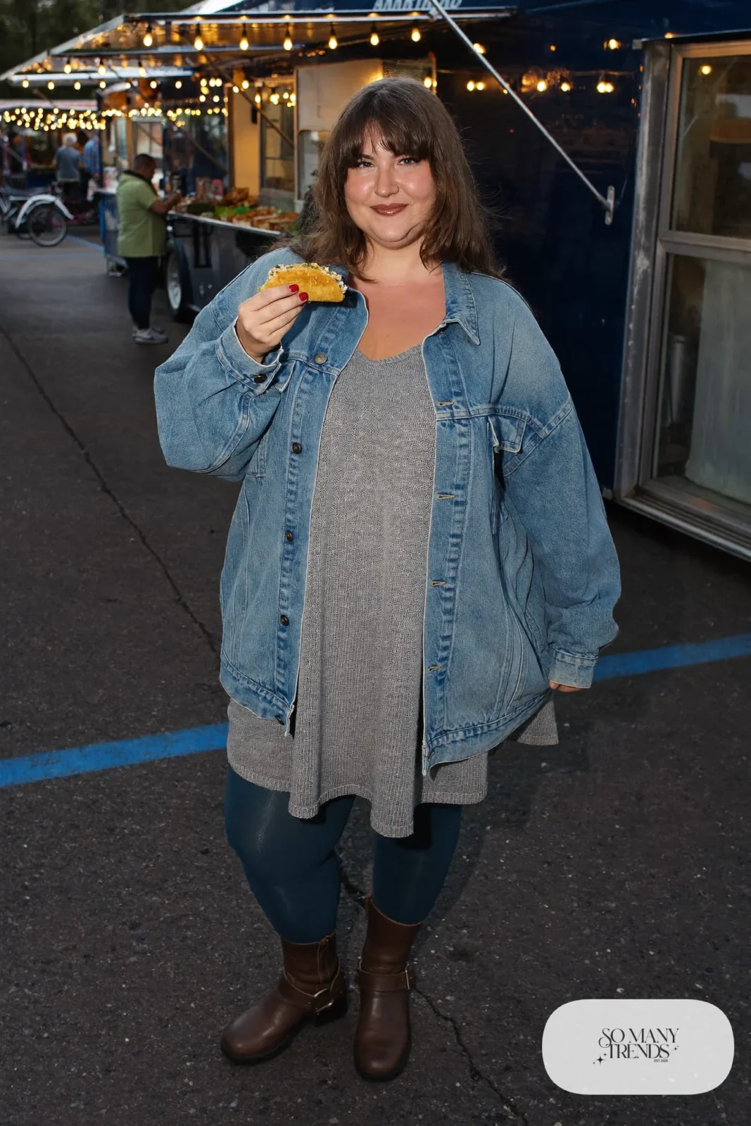 Plus size woman in gray knit midi dress, light denim jacket, belt and brown boots, outfit 28