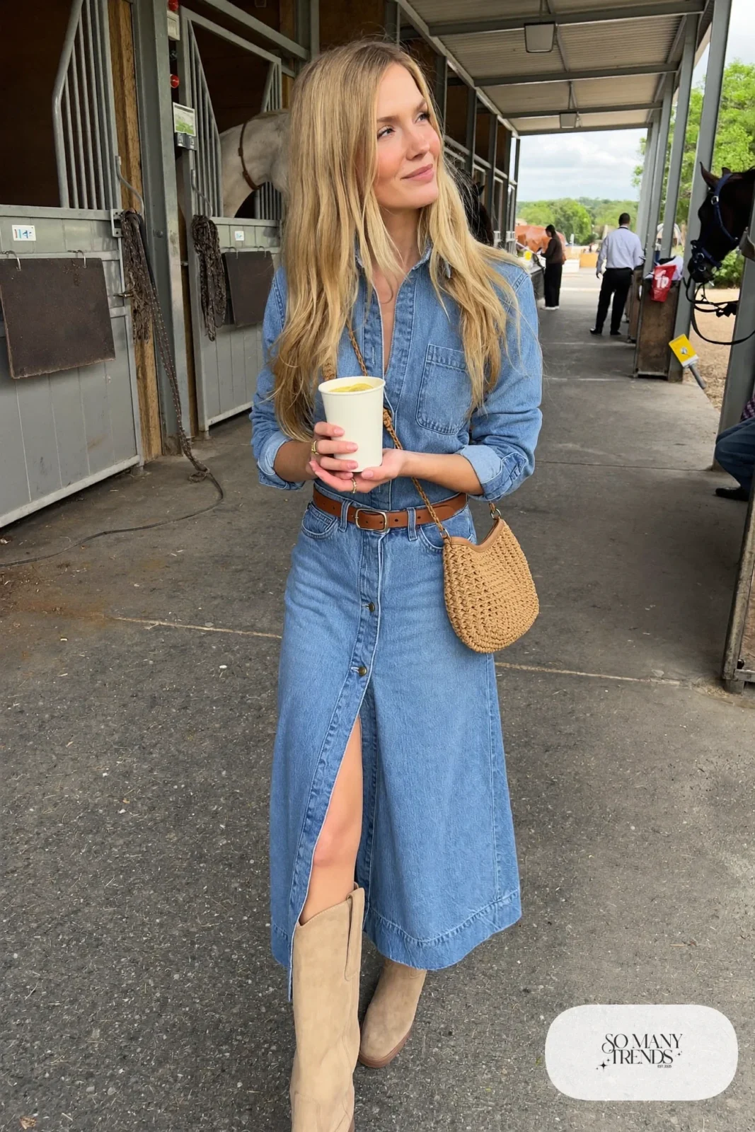 Woman in a long belted denim shirt dress with taupe suede cowboy boots, outfit 1