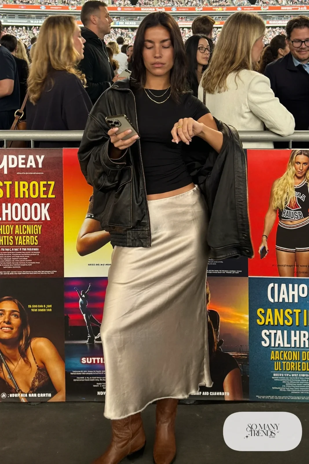 Woman in champagne satin midi skirt, black tee, black leather jacket and brown cowboy boots, outfit 3