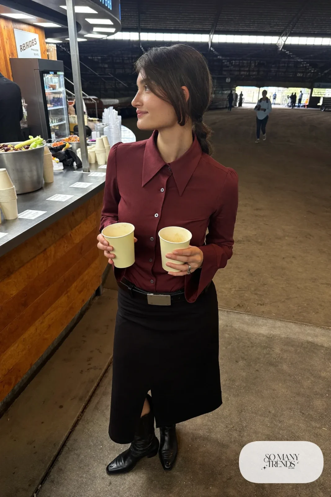 Woman in burgundy western blouse, black midi skirt and short stitched boots, outfit 10
