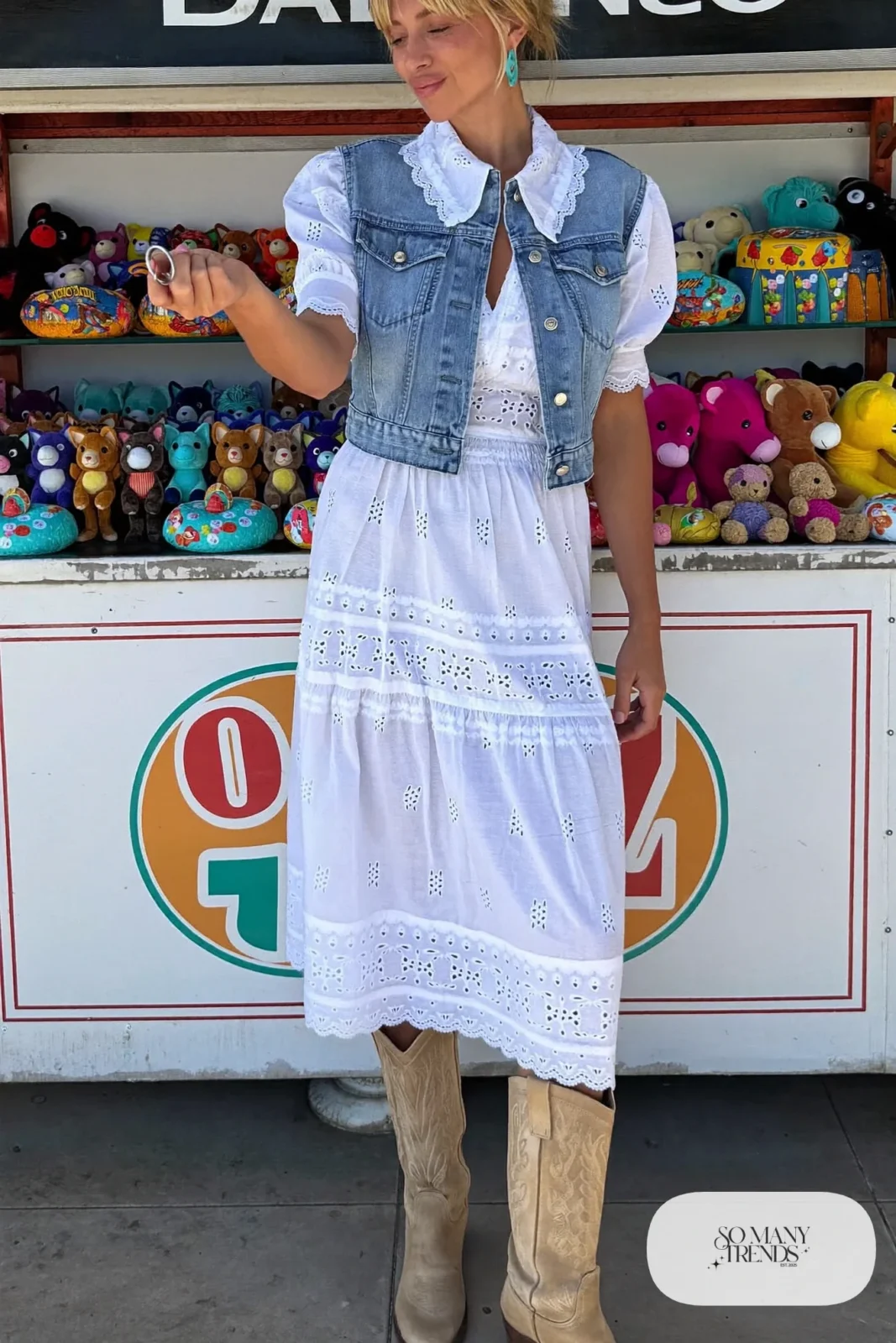 Woman in white eyelet midi dress, cropped denim vest, turquoise earrings and tan boots, outfit 16