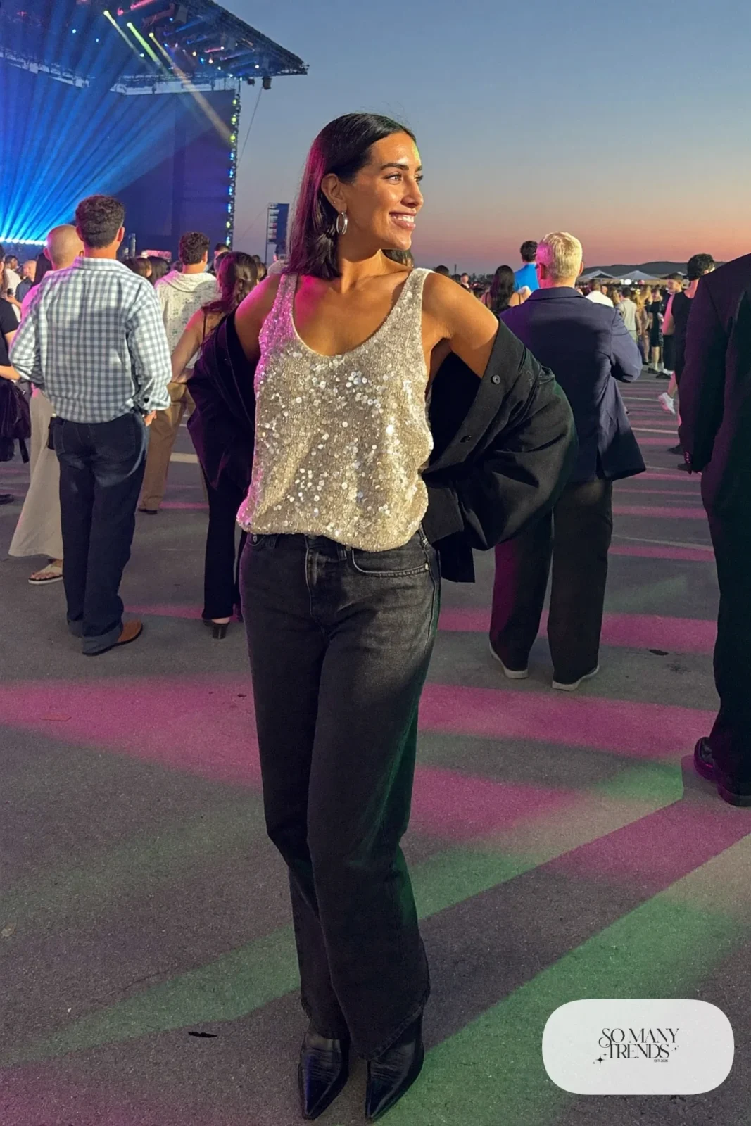 Woman in champagne sequin tank, black overshirt, black jeans and black boots, outfit 28