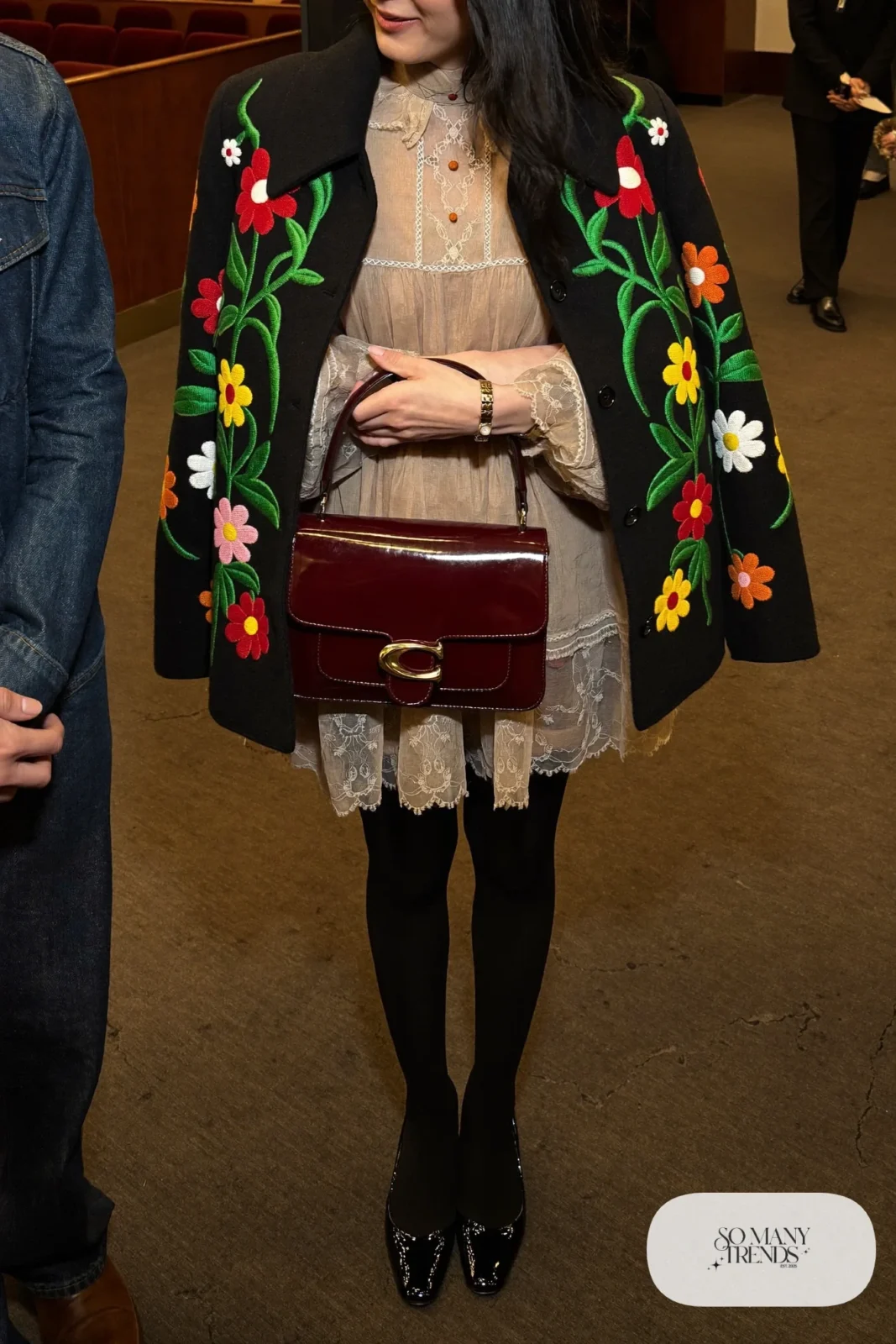 beige handkerchief-hem dress with black waist band, black wool jacket with floral embroidery, black patent pumps, burgundy bag, nutcracker outfit 6