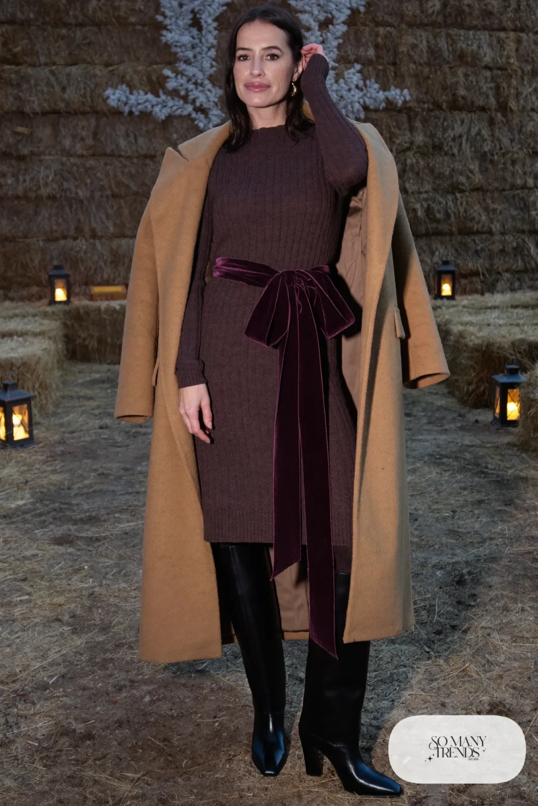 chocolate brown ribbed knit midi dress, plum velvet ribbon belt, tall black boots, camel shawl collar coat, winter wedding guest outfit 4
