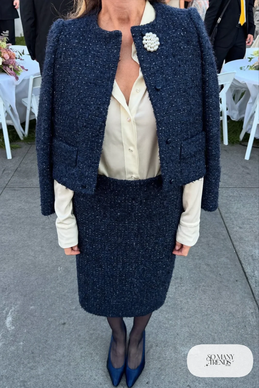 navy tweed cropped jacket and knee-length straight skirt set, pearl brooch, silk blouse, sheer tights, navy pumps, camel coat, winter wedding guest outfit 11