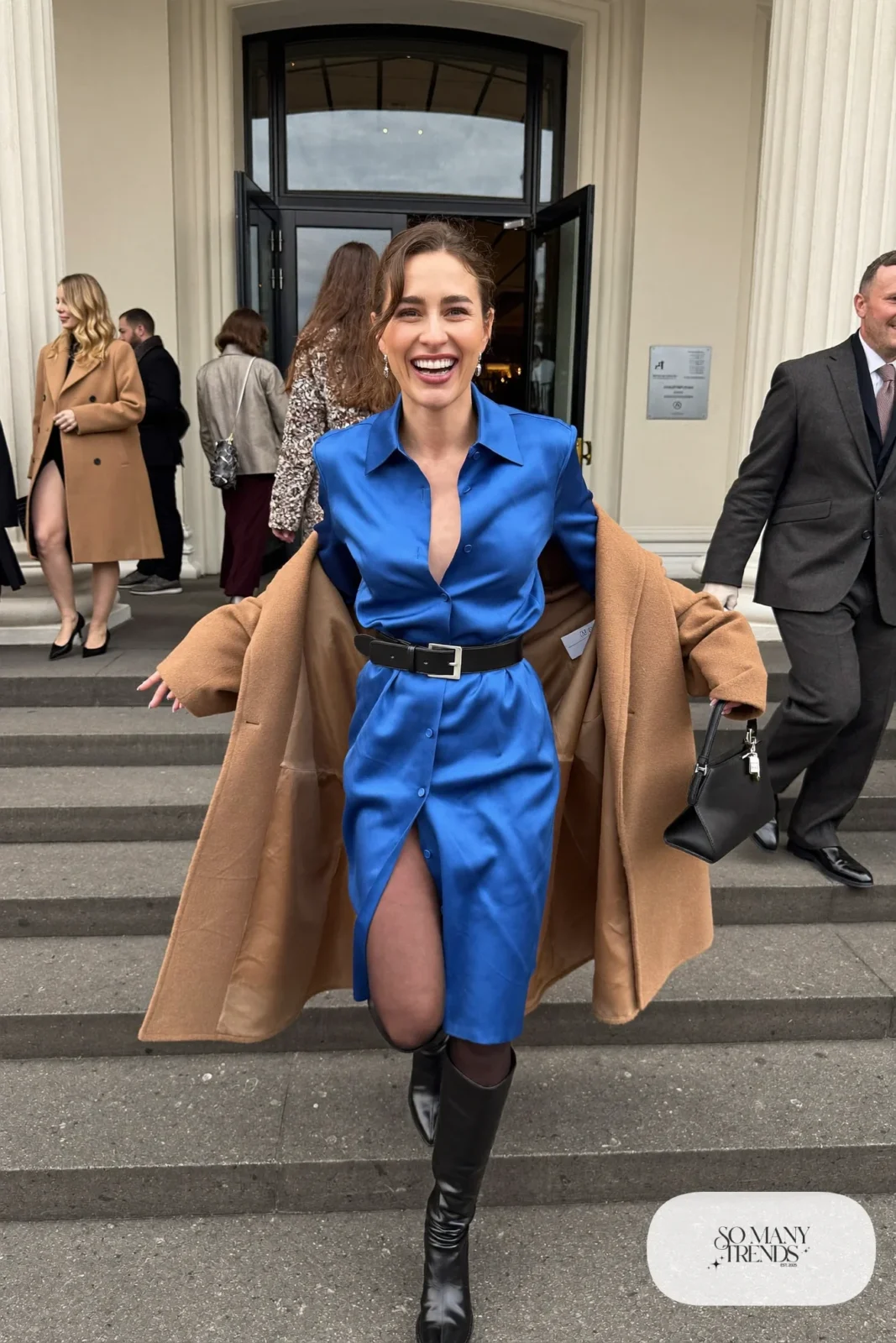cobalt blue satin long-sleeve midi shirt dress, wide black belt, black knee boots, sheer tights, camel coat, winter wedding guest outfit 19