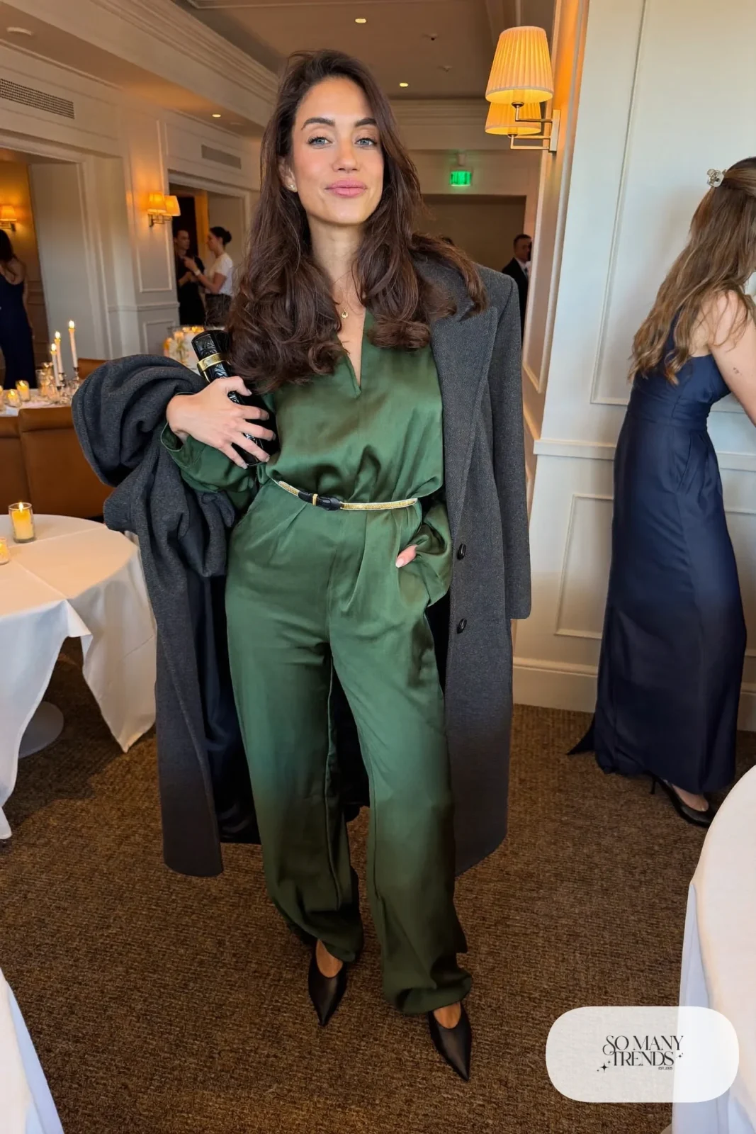 forest green satin long-sleeve wide-leg jumpsuit, thin gold belt, black pointed pumps, long wool coat, winter wedding guest outfit 23