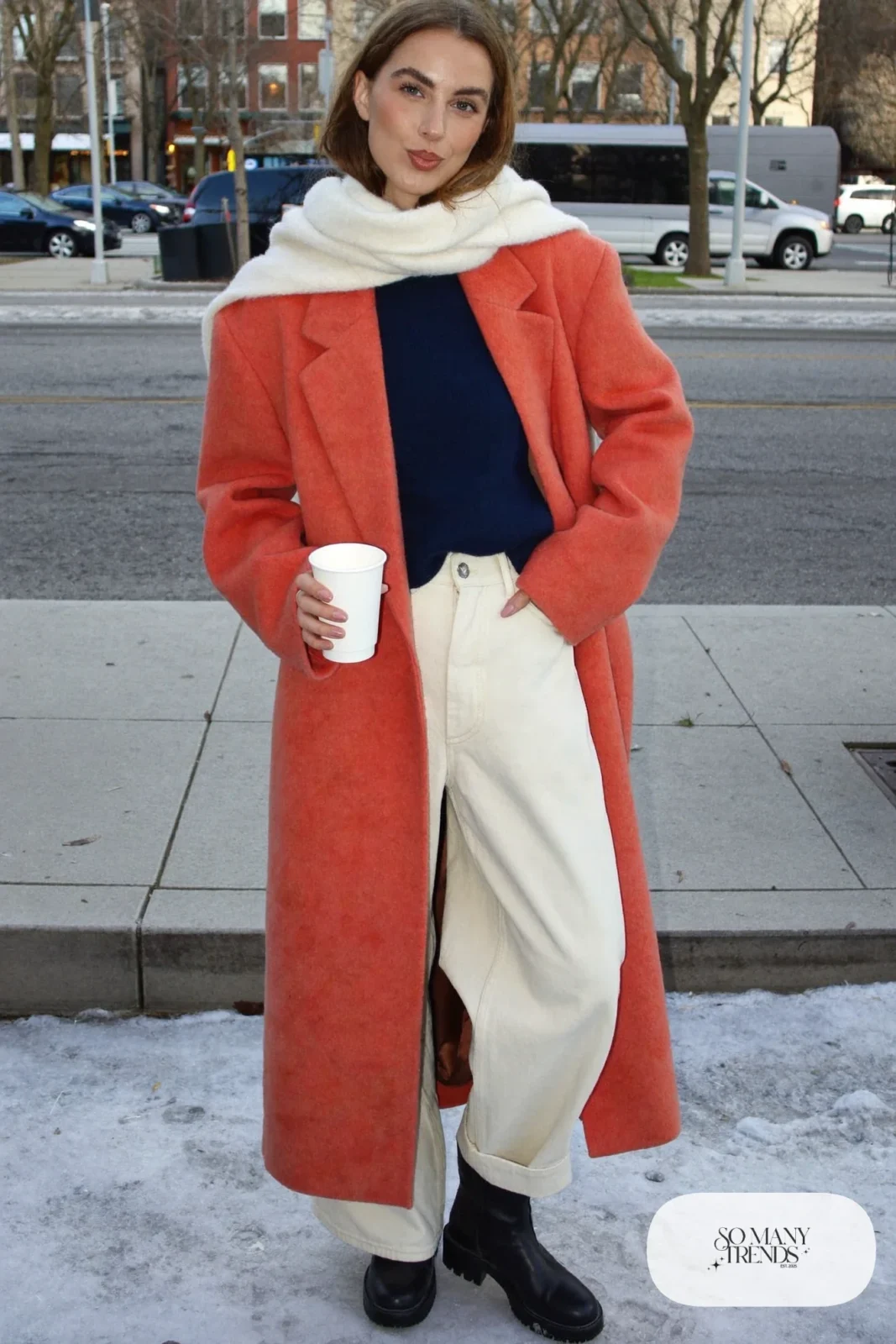 Look 1: long coral wool coat over a navy knit sweater, ivory wide-leg pants and black leather ankle boots