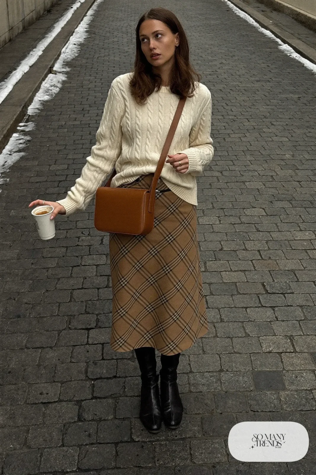 Look 13: cream cable-knit sweater, tan plaid wool midi skirt, black sleeveless layer, black knee boots and camel crossbody bag