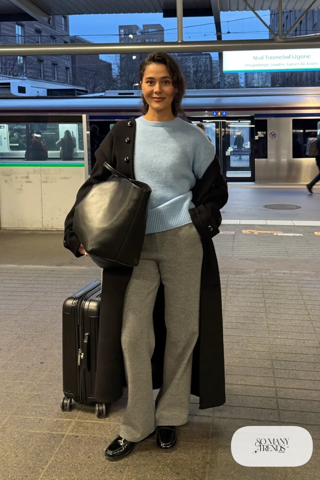 Look 23: powder blue merino sweater, gray wide-leg wool pants, long black coat and black loafers