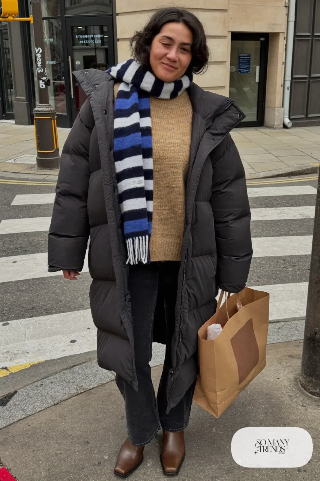 Look 24: navy and white striped wool scarf, camel knit sweater, black straight jeans and brown leather boots