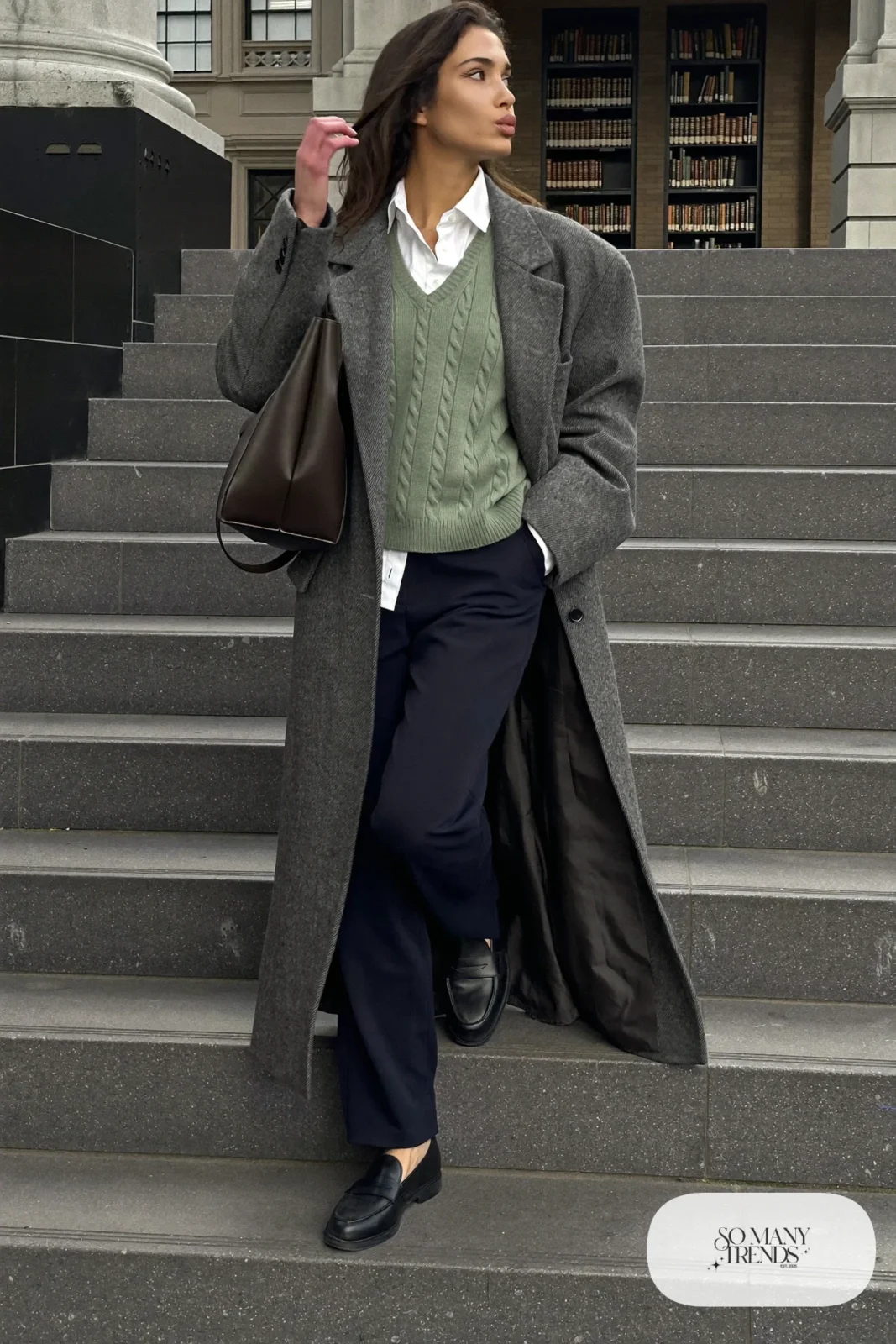 Look 28: sage green knit vest, white button-up shirt, navy straight pants, long gray coat and black loafers