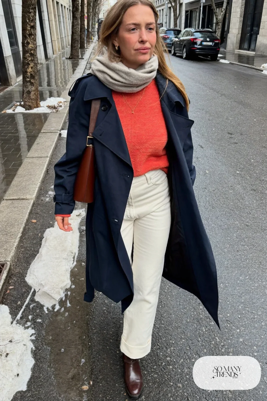 Look 30: navy trench coat, coral knit sweater, ivory pants, brown leather boots and a gray scarf