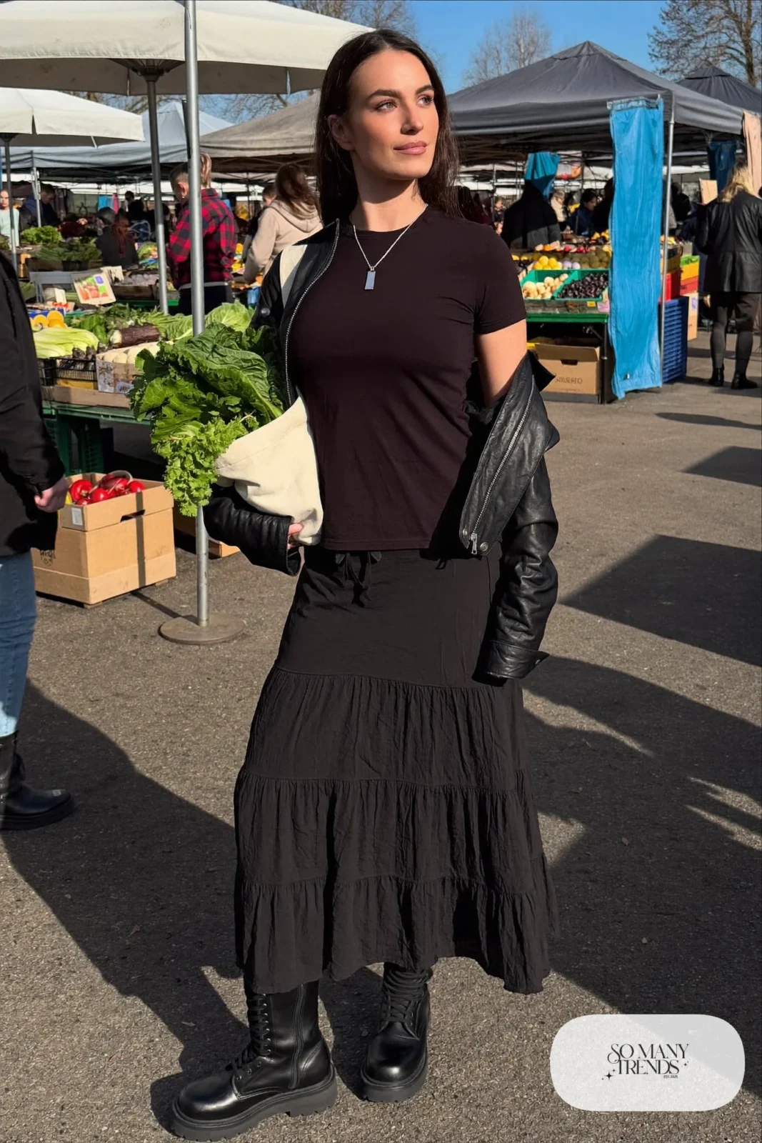 Woman in a tiered black maxi skirt, cropped leather jacket, black tee, thick tights and combat boots, outfit 32