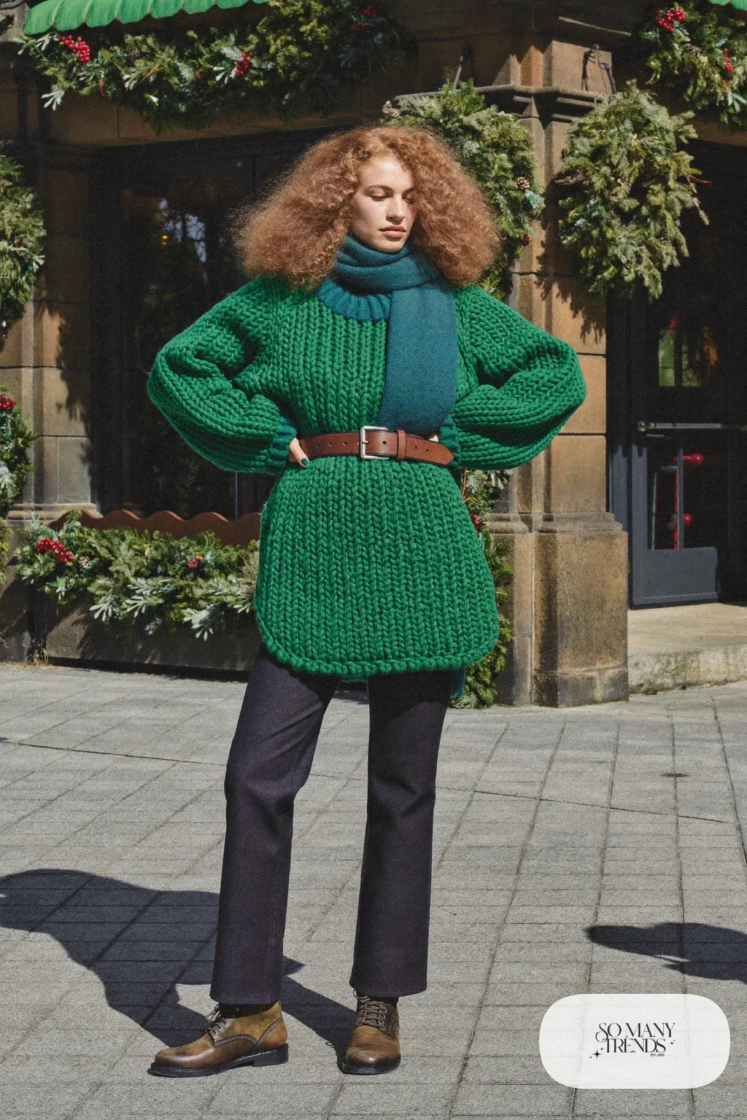 Forest green knit tunic sweater with brown belt, dark straight pants and brown lace-up flat boots, outfit 20