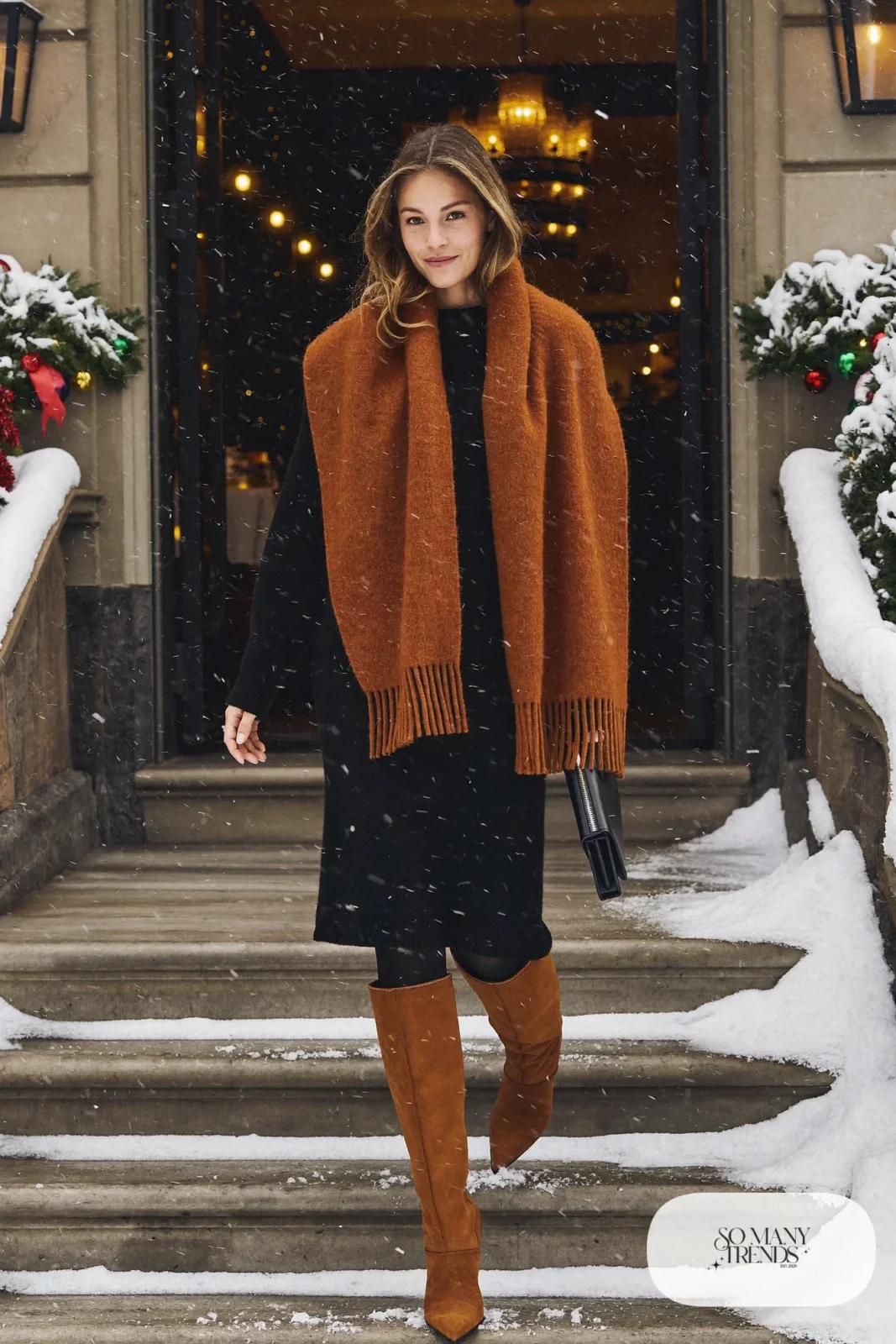 Woman in a black knit midi dress, cognac cashmere wrap, black opaque tights and tall cognac suede boots, outfit 9