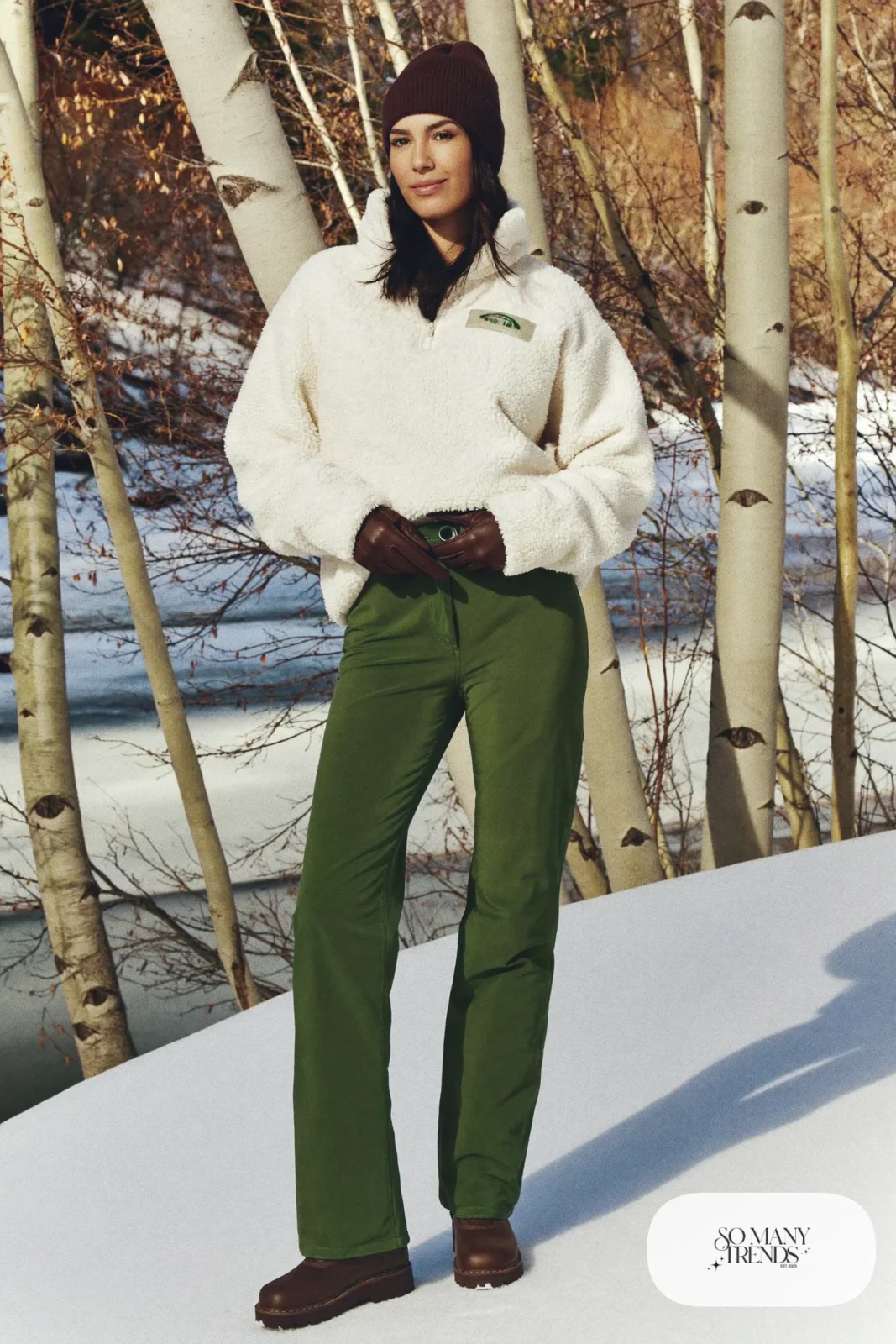 Woman in a cream sherpa half-zip pullover, moss green insulated pants, brown lug-sole boots and a knit beanie, outfit 10