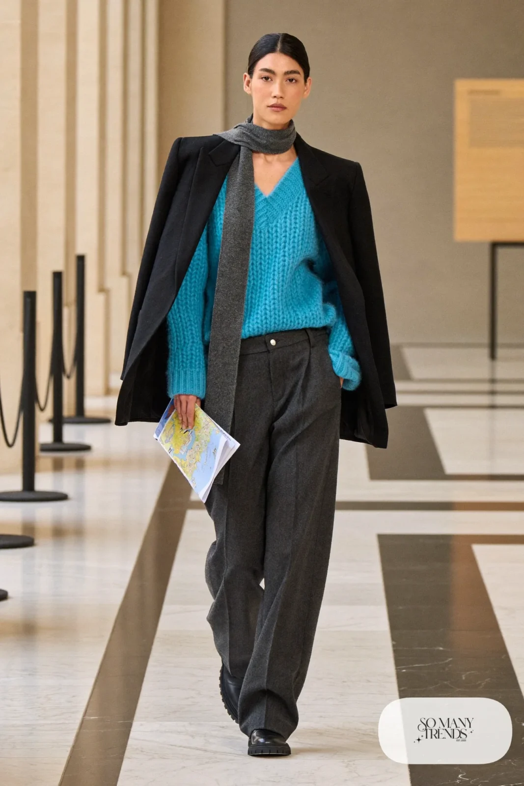 Woman in a teal knit sweater, charcoal wool wide-leg pants, a black structured wool jacket and black loafers with thick socks, outfit 2