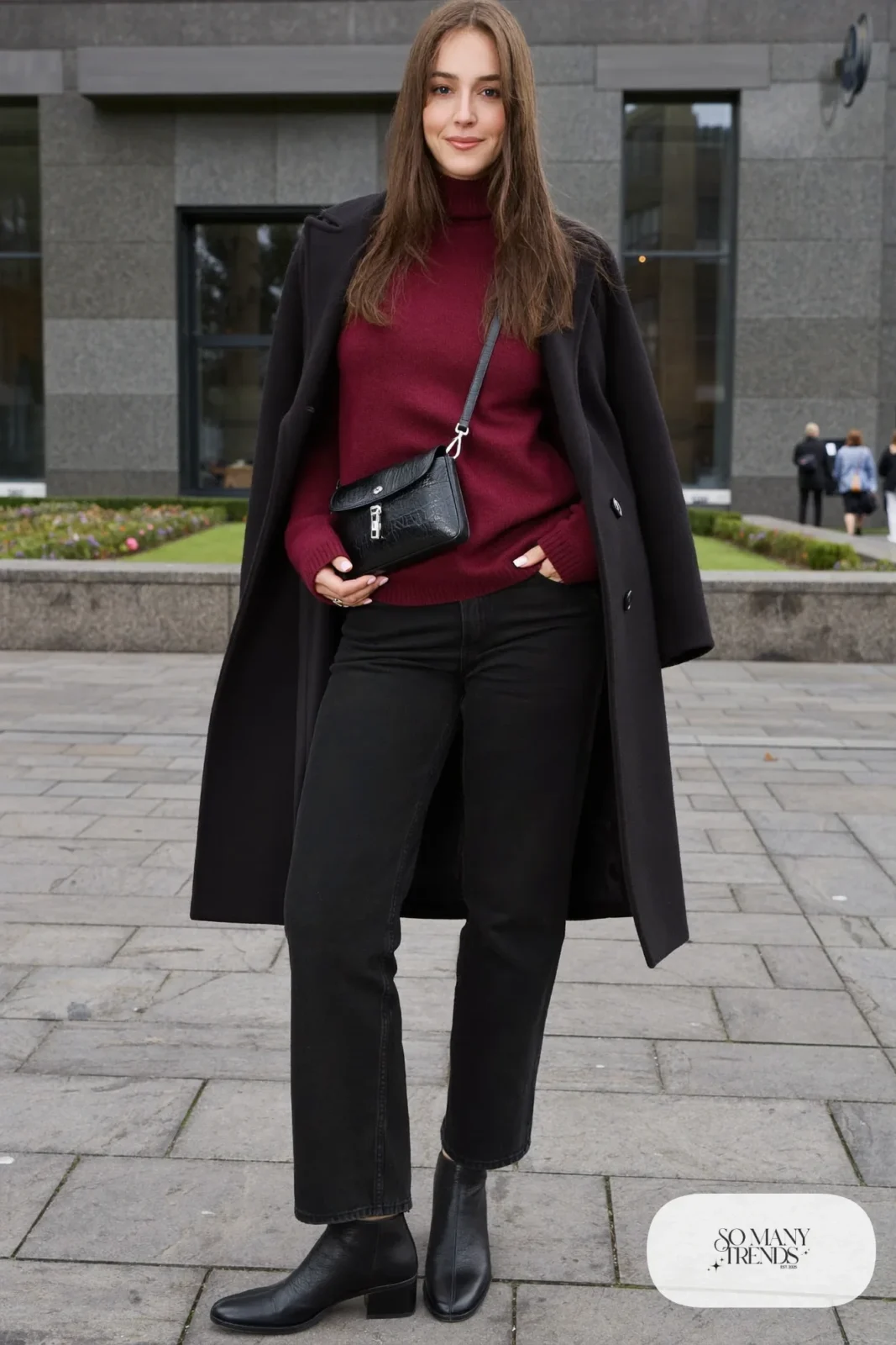 Woman in a burgundy knit sweater, black straight jeans, black wool coat and black leather ankle boots, outfit 6
