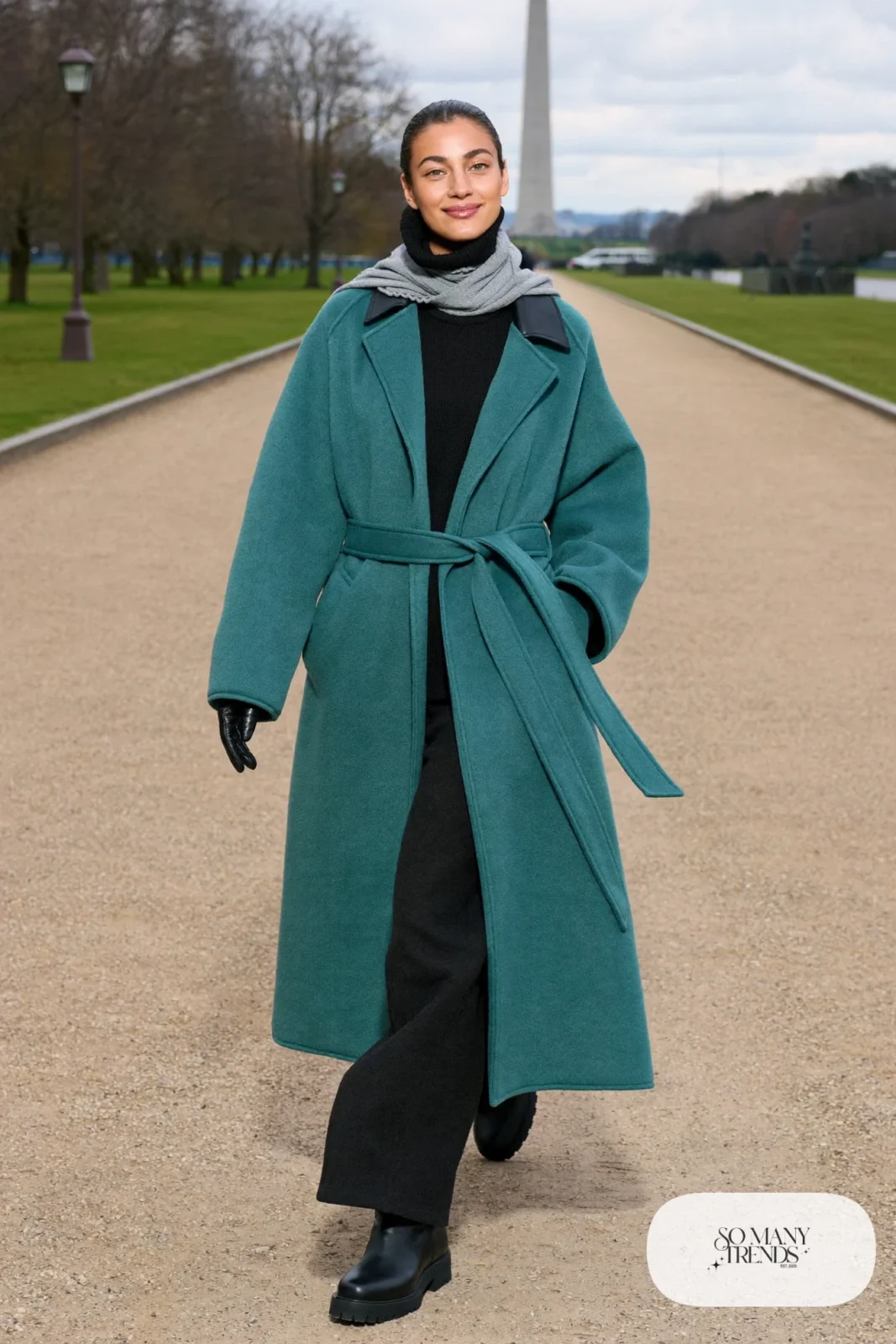 Woman in a teal wool wrap coat, black turtleneck, black pants and black leather boots on the National Mall, outfit 7