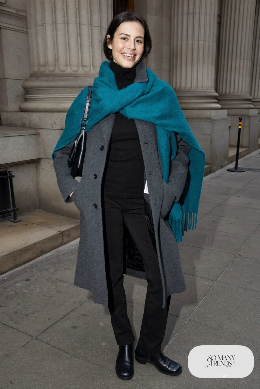 Woman in a gray wool coat, a wide teal scarf, black turtleneck, black pants and black leather ankle boots, outfit 11