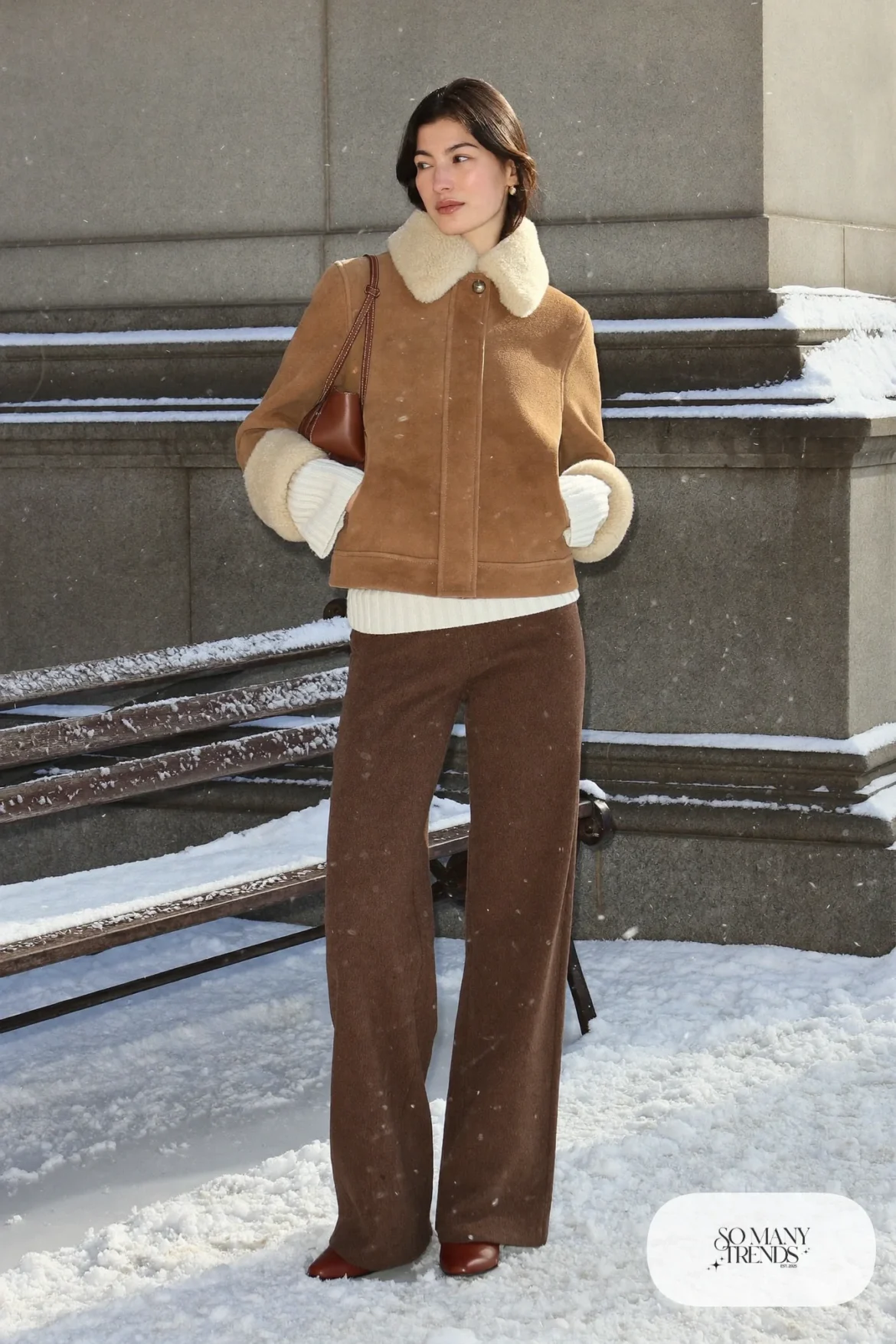 Woman in a camel suede jacket with shearling collar, ivory sweater, brown wide-leg pants and brown boots, outfit 14