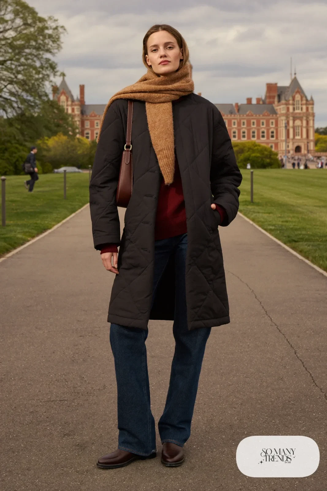 Woman in a black quilted jacket, burgundy sweater, dark jeans and brown leather boots, outfit 26