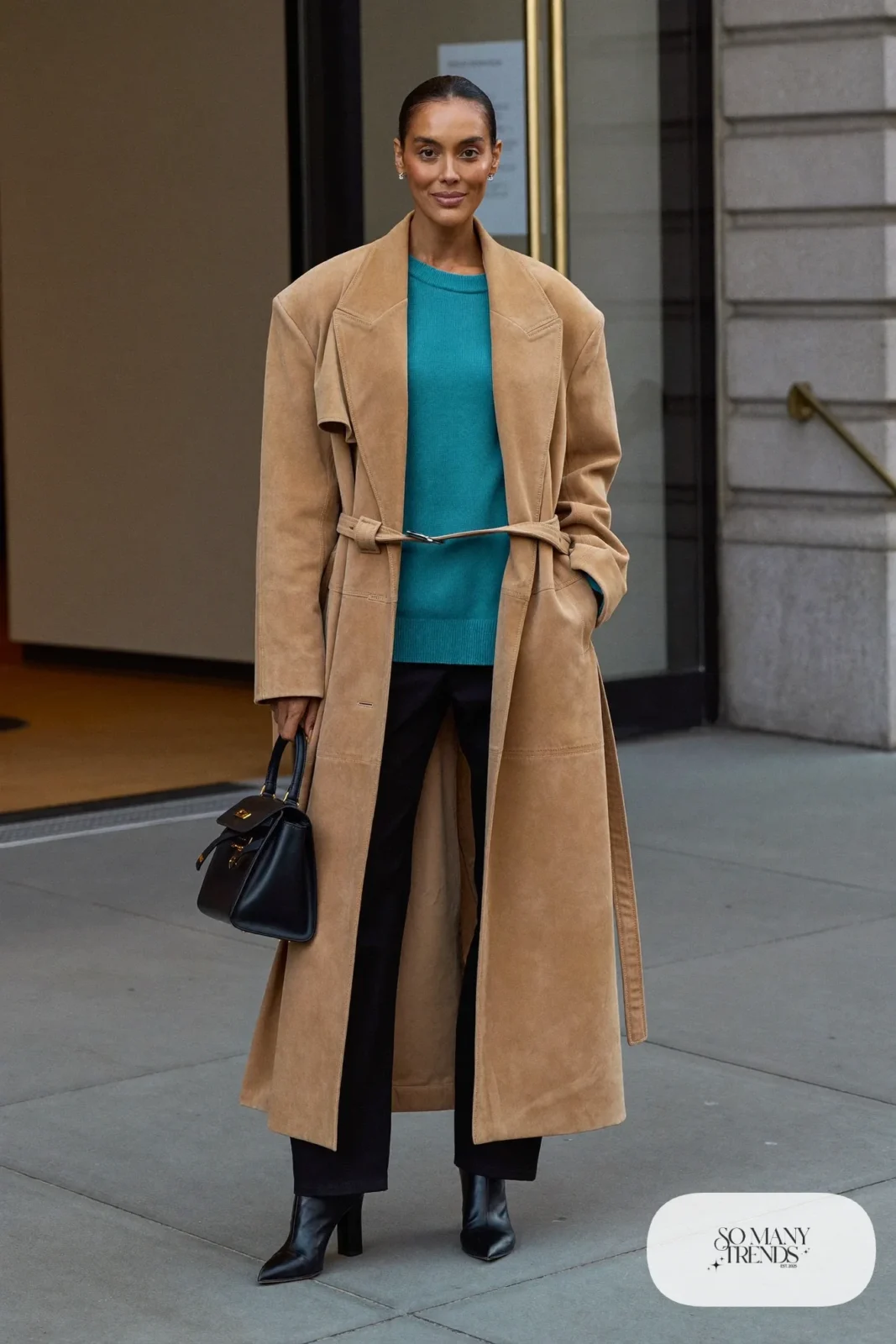 Woman in a camel suede trench coat, teal sweater, black pants and black boots, outfit 27