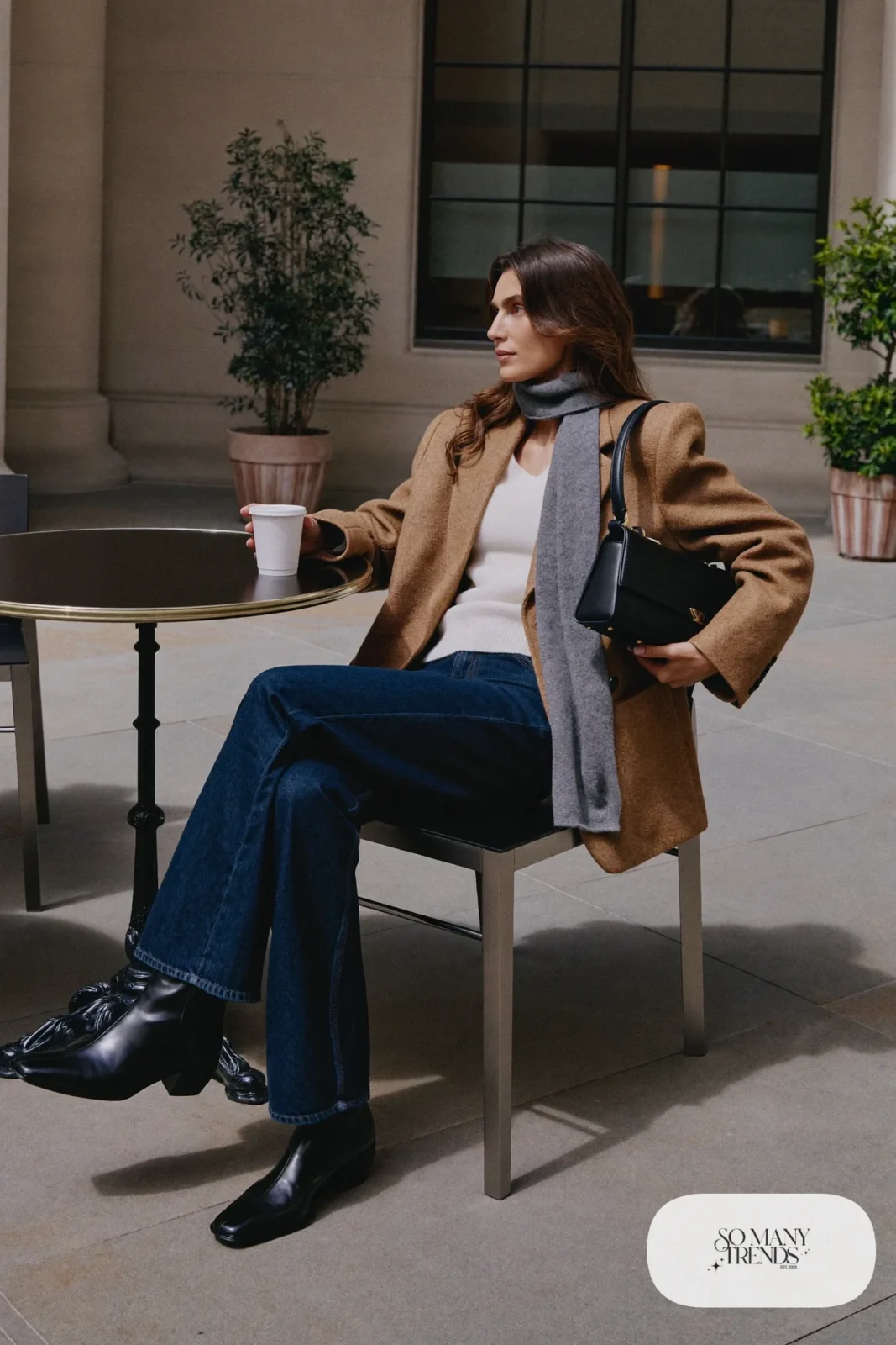 Woman in dark straight jeans, ivory sweater, camel blazer and black leather ankle boots, outfit 28