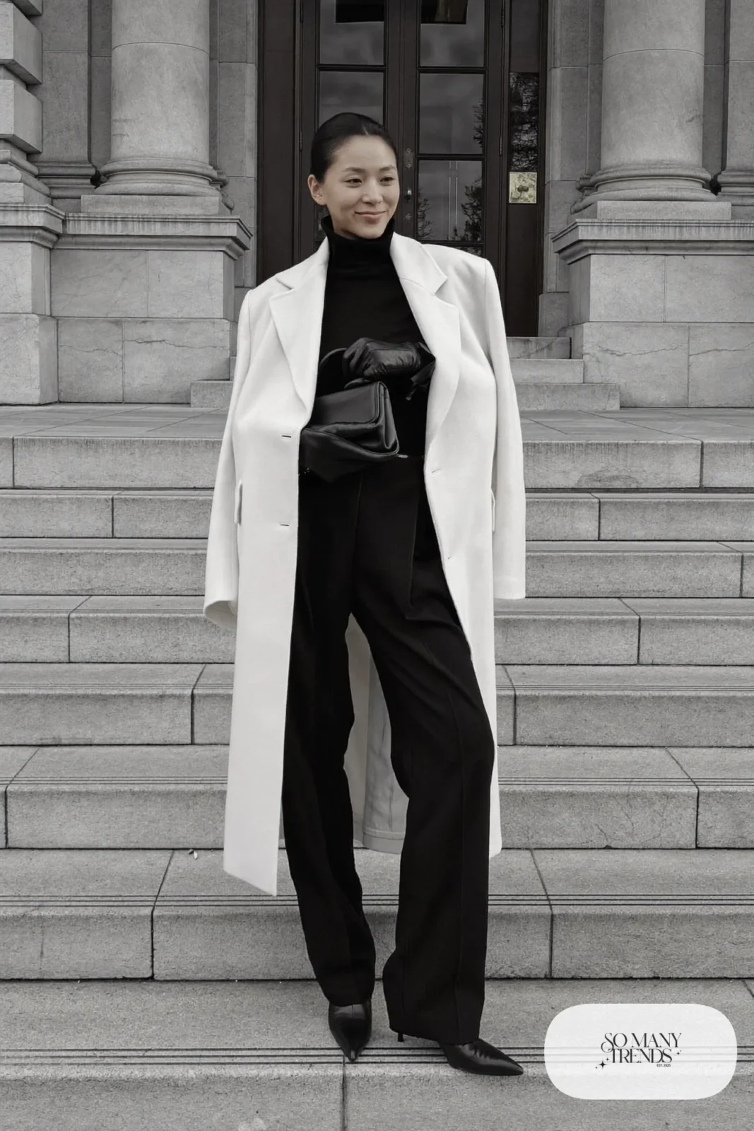 Woman in a long ivory wool coat, black turtleneck, black pants and black leather boots on a Washington street, outfit 30
