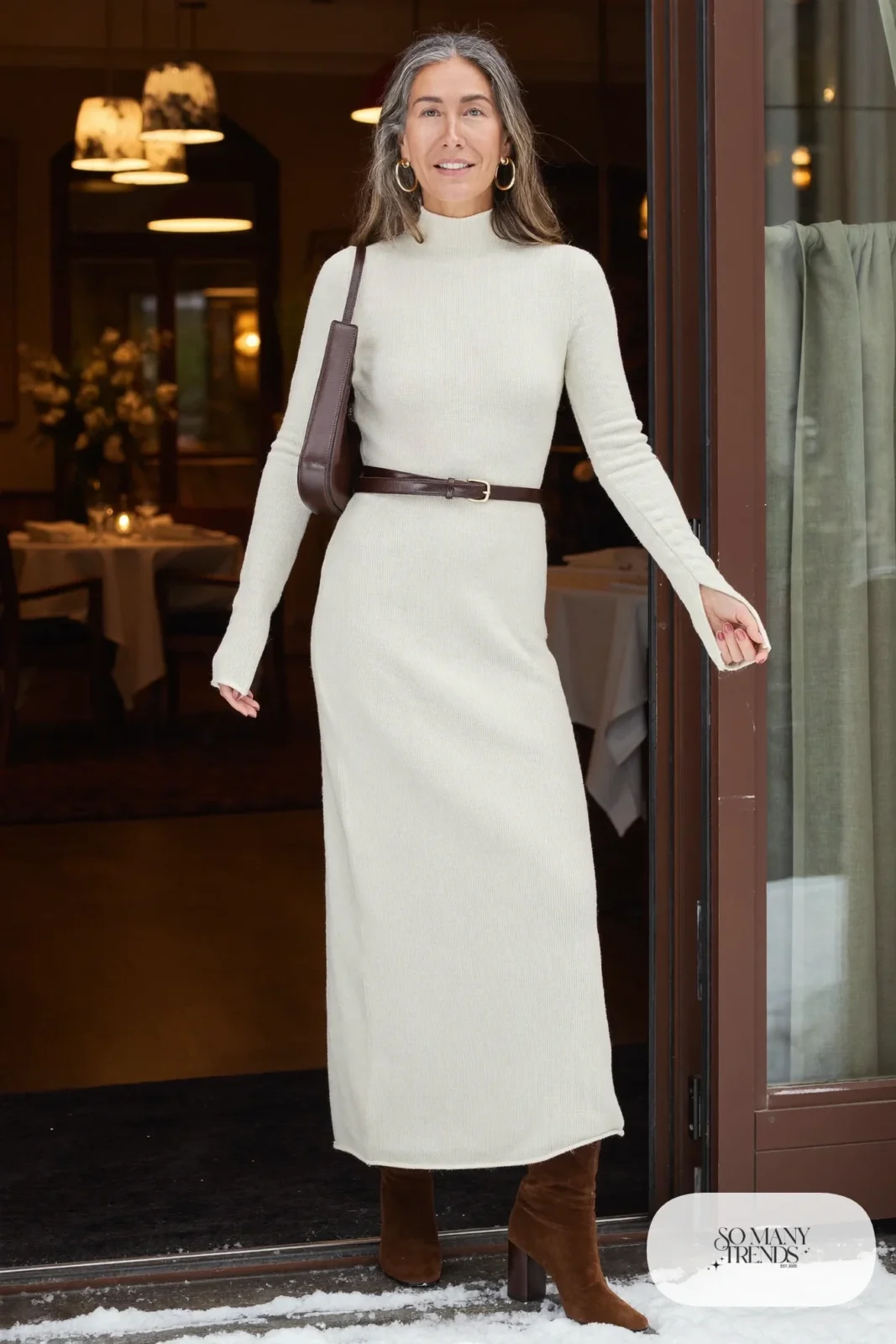Woman in a cream ribbed knit maxi dress with a chocolate brown leather belt and brown suede heeled boots, outfit 6