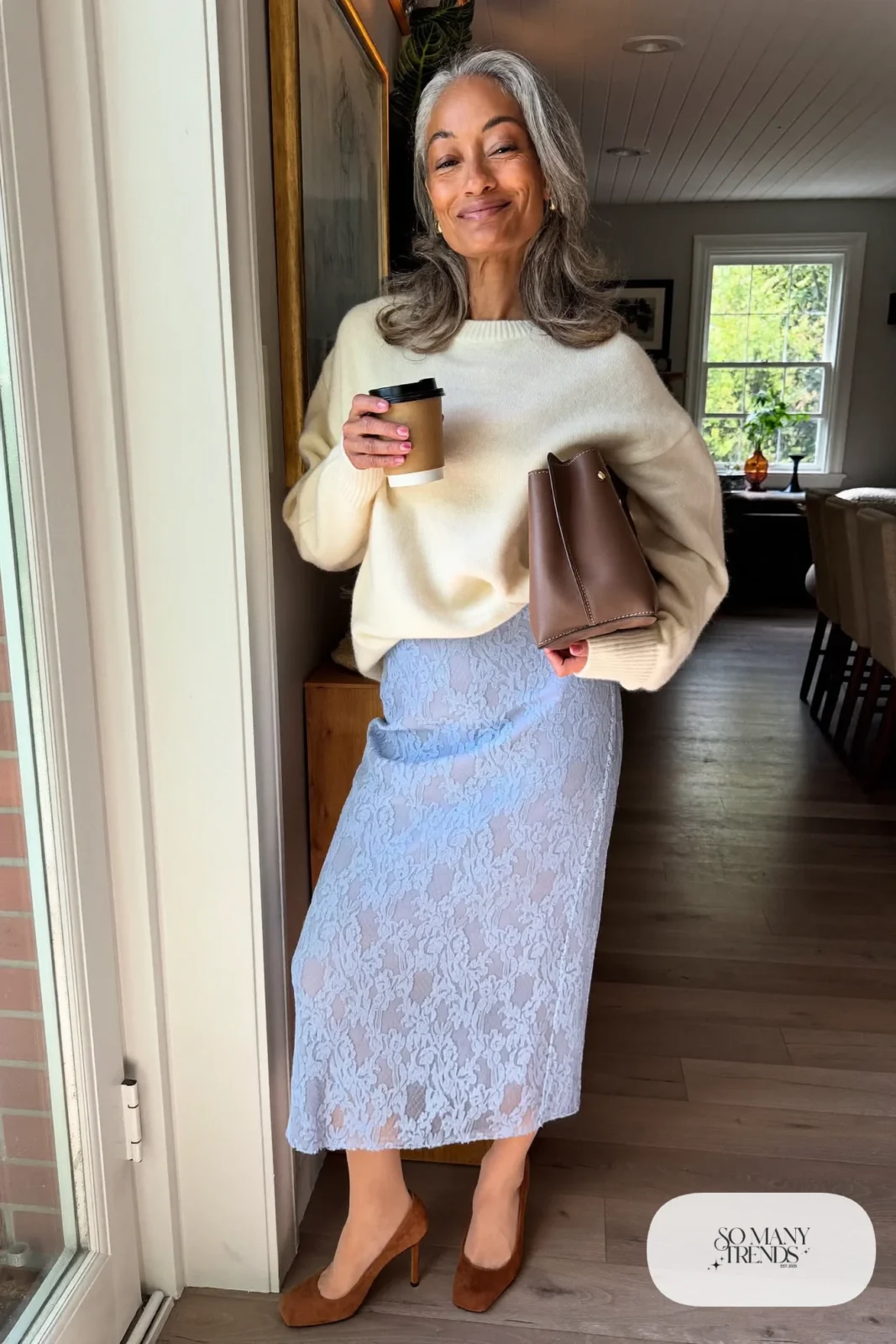 Woman in a cream cashmere sweater, powder blue lace midi skirt, sheer tights and brown suede pumps, outfit 22