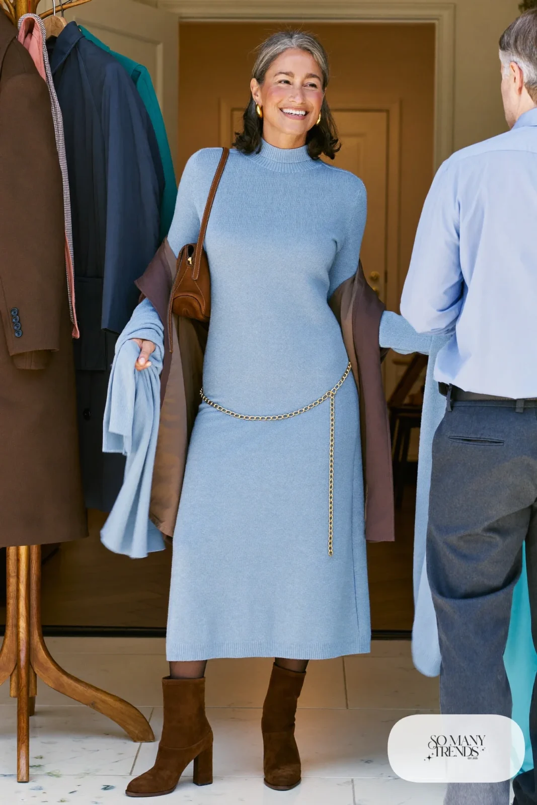 Woman in a powder blue knit midi dress with a gold chain belt, sheer tights and brown suede boots, outfit 26