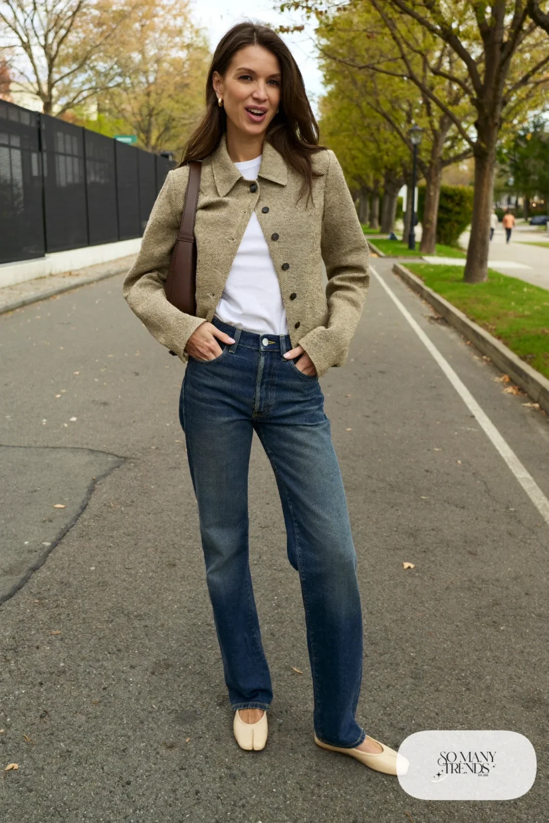 Woman in high-waisted dark jeans, oatmeal cropped jacket, white tee and tan loafers, outfit 3