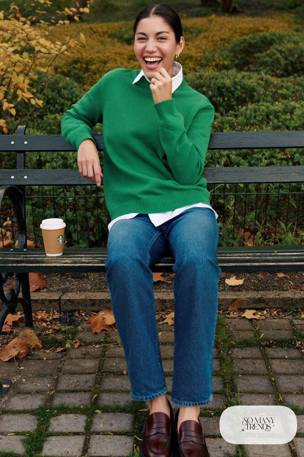 Woman in pine green merino crewneck, white collared shirt, straight jeans and loafers, outfit 11