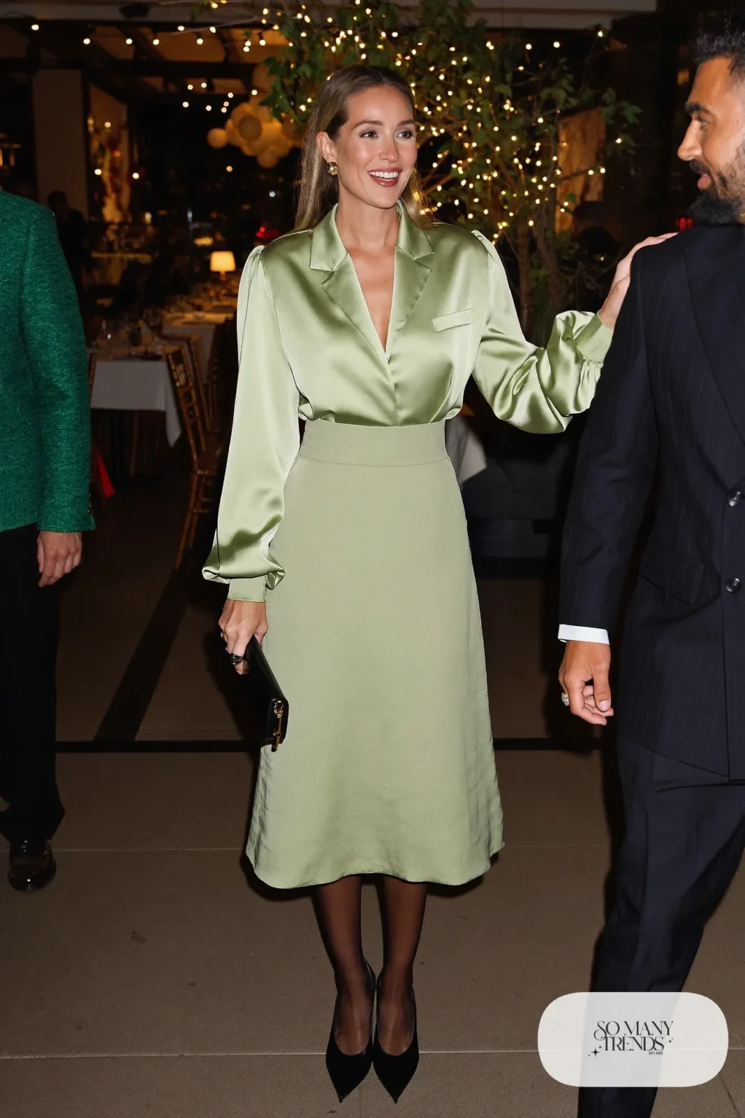 Woman in a sage satin two-piece set with midi skirt, sheer tights and black pointed pumps, photo 20