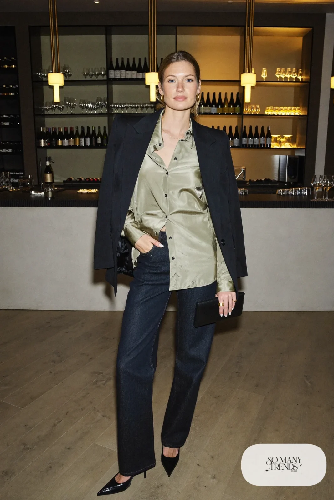 Woman in dark straight jeans with a sage satin blouse and black blazer with pointed heels, photo 25