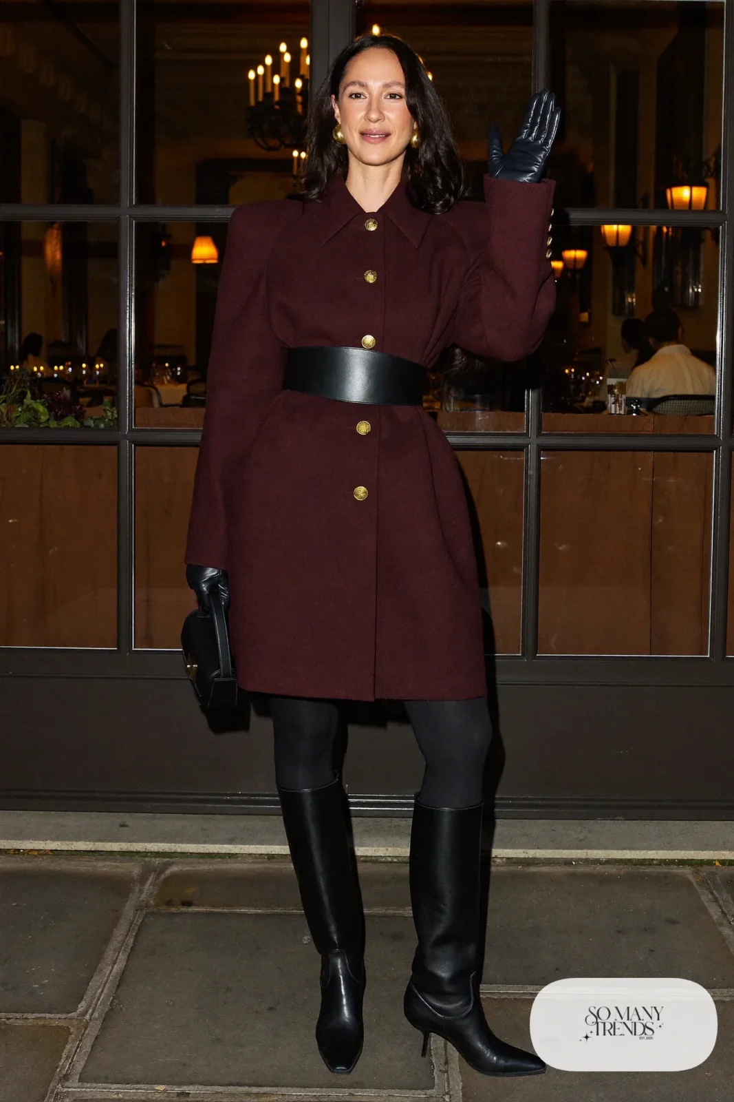 Woman in a deep wine double-breasted wool coat dress with wide black belt and tall black boots, photo 4