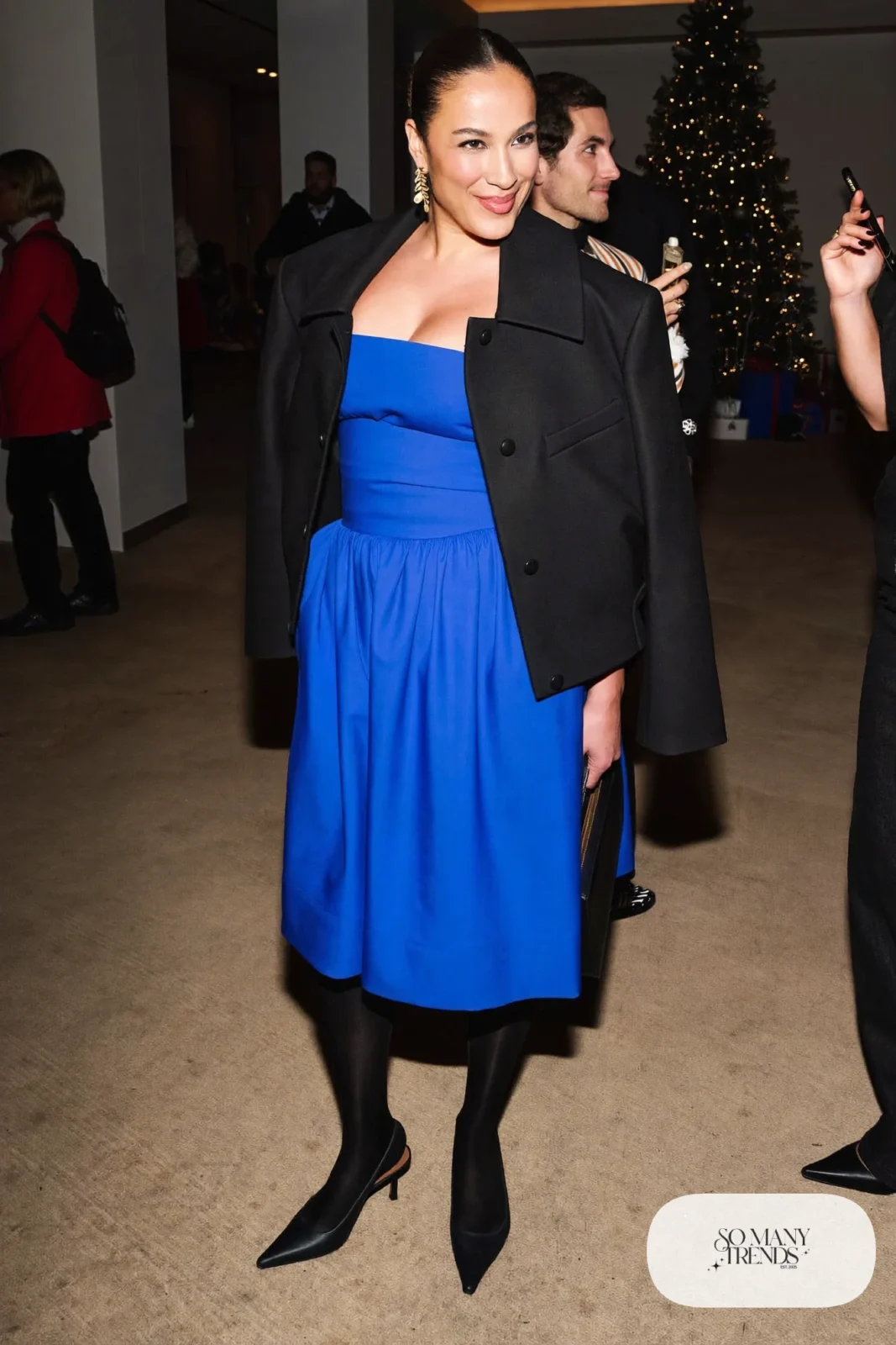 Woman in a cobalt crepe dress with a cropped black wool jacket, sheer tights and black slingback pumps, photo 6