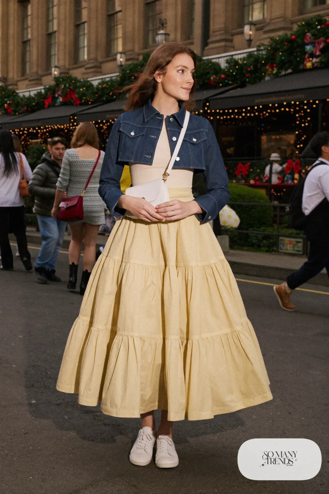 Butter yellow tiered midi skirt with cream ribbed top, gold belt, cropped indigo denim jacket and white sneakers, outfit 1
